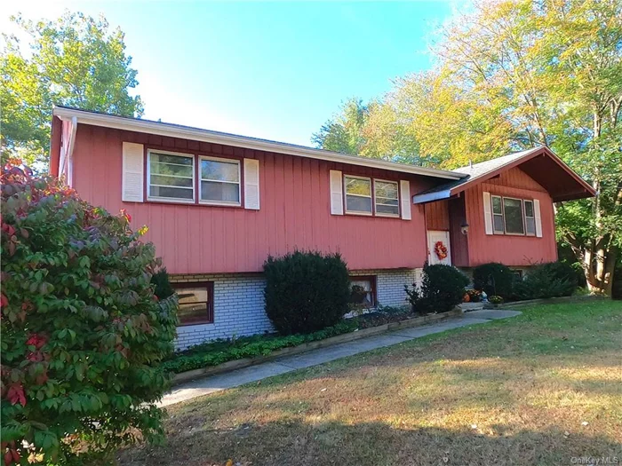 Enjoy the privacy of a cul-de-sac Raised Ranch located on nearly an acre of land with access on the property to a lake within sight distance of the rear deck. There is plenty of room in this spacious 2145 sq ft living area with a formal dining room off the eat-in kitchen. Hardwood floors throughout and a primary bedroom, walk in closet and full bath makes this home special. Two full baths on the main living area and a half bath in the laundry room down stairs for easy living. Have fun in the play room bar area for entertaining and there is a walkout slider door to a fenced in area in the backyard. Cozy up to the fireplace to relax after a hard day. No need to worry about heat in winter with a new boiler installed less than a year ago along with the hot water storage (indirect tank) plus the roof was installed in 2012.