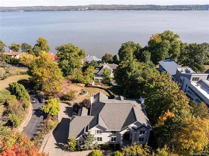 HUDSON RIVER HAVEN - Welcome home to Nyack&rsquo;s finest address at 2 Tompkins Court, Upper Nyack, NY. This exclusive area in Upper Nyack is an exhilarating, private enclave of seven homes with Hudson River access via a private rocky beach. Located on the former estate of Supreme Court Justice Tompkins, this single-family home, built in 2005, is more than just a residence; it&rsquo;s an embodiment of modern elegance and a testament to meticulous craftsmanship. Aside from living in luxury, 2 Tompkins Court is situated on a spectacular .63 acre site with Hook Mountain in the background, and the east bank of the river in the foreground, acting like a perpetual mural that changes by the season. Completely turn-key, this 5096 SF residence flaunts river views from almost every room. This six-bedroom, four-and-a-half-bathroom home is a sanctuary of tranquility, providing a perfect blend of contemporary living and timeless design. Upon entering, the foyer welcomes you with its warm ambiance and sets the tone for the rest of the home. The open-concept great room with 18&rsquo; ceilings and fireplace seamlessly connects to the culinary kitchen, equipped with breakfast nook, state-of-the-art appliances, custom cabinetry, and exquisite granite countertops, flaunting river views from all windows. Off the kitchen is the formal dining room with lush river view vistas, fireplace and a second walk out to the outdoor oasis. The primary suite is a haven for relaxation, featuring a spacious layout and a private en-suite bathroom. Five additional bedrooms provide ample space for family members or guests, each thoughtfully designed with comfort in mind. The home&rsquo;s layout ensures privacy and fosters a sense of togetherness, making it an ideal space for both intimate gatherings and lively celebrations. If your indoor space isn&rsquo;t enough, 2 Tompkins Court also includes a three car garage and fully finished basement with home gym, billiards, movie theater and potential for wine cellar. Outside, the expansive patio is perfect for al fresco dining or simply enjoying the serenity of the mighty Hudson River. The meticulously maintained garden is a burst of color and fragrance, creating a tranquil retreat right at your doorstep. Located near Hook Mountain Park with miles of riverfront hiking/biking trails, Upper Nyack community tennis court, Upper Nyack Field Club, Nyack Boat Club and best of all, the historic Village of Nyack is walking distance or a short bike ride away. The property is conveniently close to NYC transportation with the Mario Cuomo Bridge only 5 minutes away and the GW Bridge just 20 minutes away. If you are seeking an unparalleled lifestyle with impeccable river views and water access, come witness Hudson River Haven and arrange your private tour today.