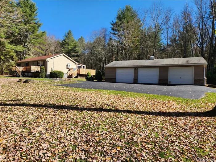 Private 3 bedroom, 2.5 bath ranch home tucked back off the road on park-like 3.43 acres. Updated kitchen with gas stove, dishwasher, tile floor and dining area. Bathrooms updated as well with new facilities, lighting and flooring. Enclosed porch adds extra living space and walks out to side deck for grilling and chilling. Front deck off the living room is perfect for relaxing. Lower level adds 1008sf of newly renovated family room, bar area, pellet stove, cool laminate flooring, large full bath, bonus room, separate laundry room and storage room. Gorgeous property boasts 1056sf 3 car garage and an enormous 1008sf workshop or art studio, car, boat, bike, snowmobile storage. Many possibilities. Make this your primary home or a vacation destination. Gorgeous grassy knoll is massive and encircled with a lightly wooded forest. Very peaceful atmosphere and extremely pleasing to observe. This private oasis in Sullivan County is nearby to Bethel Woods, Resorts World Catskills Casino, Kartrite Resort and Indoor Waterpark, farmer&rsquo;s markets, festivals, waterfront dining, mountains, lakes and rivers. Everything the Catskills Mountains have to offer!