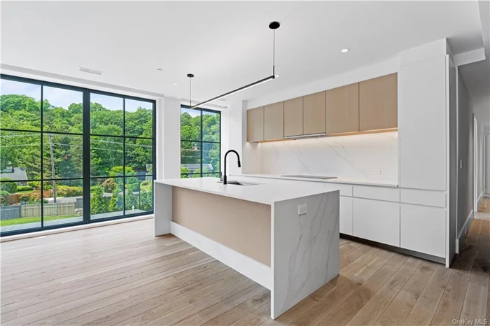 This large 2-bed with 2-baths features floor-to-ceiling windows, an open kitchen with modern finishes, appliances by Wolf, Bosch, & SubZero, and a gas linear fireplace. The primary bedroom has an en-suite bath with heated floors and a bonus space with bright natural light. Originally a candlewick mill built in the 1800s and later a destination for artists to maintain their studios, The Mill Westport has been completely reimagined into 31 unique residences by Coastal Luxury Homes & Gault Family Companies. Amenities by globally recognized designer Philip Hazan brings a hotel-inspired experience, including a beautiful patio with pool, hot tub, grilling area, lounge, gym, & a common rooftop terrace. *Images rep finishes. Ask about taxes. IMMEDIATE OCCUPANCY! Parking & Storage included!