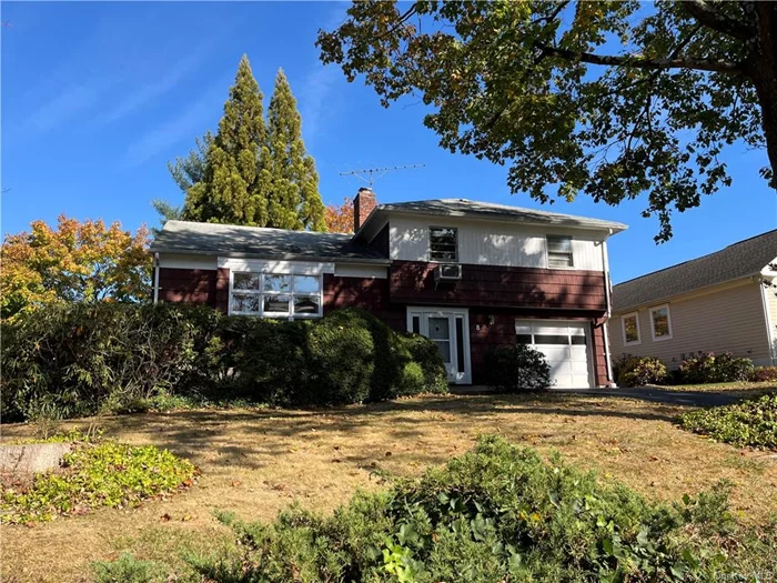 Amazing opportunity in this well maintained mid Century Split level home located on a lovely Woodcrest Heights street. Oversized property with an attached garage, full basement is positioned to capture the morning sun from the east and afternoon western sunsets flooding the home with light. Soaring, cathedral ceilings in the Living Room, a formal Dining Room which could be opened to the large eat in Kitchen have a wonderful flow on the main floor. An above ground, entry level Rec/Playroom with a fireplace and door out to the backyard is an added bonus! All 3 Bedrooms and full Bath are located on the 2nd floor. Large yard has mature plantings providing privacy and a patio as well for relaxing or entertaining. New electric service is needed and cosmetic updates to have an absolute gem!