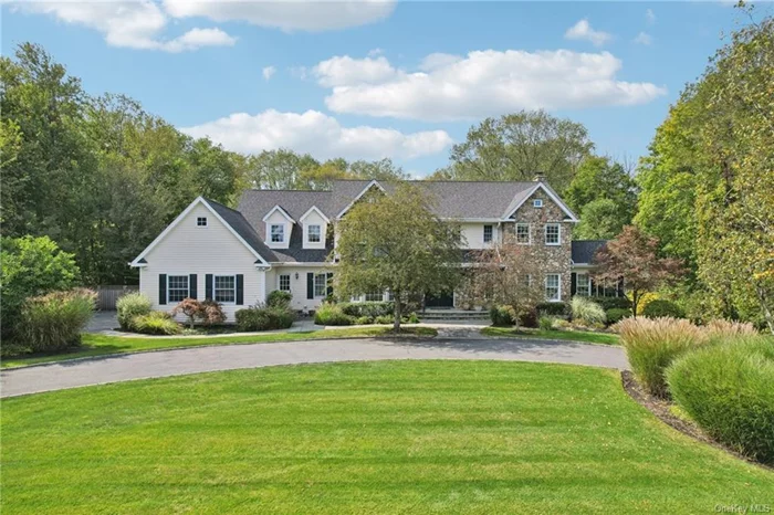 Welcome to this majestic home set on 2.8 acres of spectacular parklike property on one of the most beautiful cul-de-sacs in Wesley Hills. Set back on magnificently landscaped grounds, this custom designed cedar and stone colonial exudes timeless elegance and quiet luxury. Upon entering the home, you will be enchanted by the soaring ceilings, the abundance of windows, the gracious curved staircase, and the gorgeous hardwood floors. You will be captivated by thoughtful architectural details including stunning built-ins, handsome millwork, and inviting window seats. Through two sets of French doors, enter the luxurious living room or the banquet sized dining room. The heart of the home, the recently updated custom gourmet kitchen, features classic white cabinetry, quartzite countertops. and sophisticated Wolf and Sub-Zero appliances. The kitchen opens to the sun-drenched family room where you will appreciate the ever-changing wonders of nature, whether curling up with a book by the stone fireplace or stepping outside to the expansive two-tier deck. Two bedrooms, a full bathroom, a laundry room, a separate mud entrance, and a three-car garage complete the first floor. Retreat upstairs to the spacious primary suite with a vaulted ceiling, two large walk-in closets, a marble vanity with a sink, and a lavish marble ensuite bathroom with double sinks and radiant heat. Down the hall, there are three additional bedrooms with crown moldings, window seats, and a tray ceiling. Two bedrooms share a Jack and Jill bathroom with two sinks, and one is equipped with an en suite full bathroom. In addition to an attic that runs the length of the home, adjacent to one of the bedrooms is a bonus storage room. Do not miss the sprawling walkout lower level which boasts 1560 additional square feet of living space, including a large guest bedroom, a full bathroom, two playrooms, a media room, a gym, a kitchenette, and a wall of closets. There is also a large unfinished space used for storage. The backyard oasis features a heated oversize saltwater swimming pool and spa, with a retractable cover, surrounded by an exquisite stone patio, fields of lush lawn, lovely gardens, an above ground vegetable and herb garden, a tranquil forest, and a babbling brook that meanders to a serene pond at the rear of the property. Most of the energy for the home is provided by fully owned solar panels and stored on three Powerwall batteries. The home is equipped with multiple heating and cooling zones, an in-ground sprinkler system, a security system, a sound system, two electric vehicle charging stations, and a natural gas generator. Just 30 miles from the George Washington Bridge, this is a rare opportunity to create new memories in the home of your dreams.