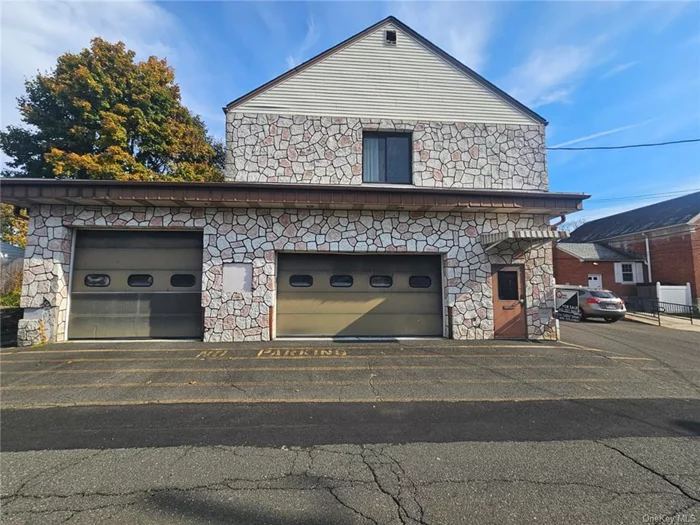 This versatile two-story masonry and wood-frame building, formerly the Stony Point Ambulance Corps, is in excellent condition and ready for various uses. The first floor features a spacious garage with drive-in truck bays and overhead doors, ideal for contractors, service businesses, or storage. The second floor offers an open area suited for offices, conference rooms, or workspaces, complete with a kitchenette and bathrooms. The fully paved lot accommodates nine cars, making it convenient for clients and staff. Currently zoned for office use, other uses would require a zoning variance. This property combines functionality and flexibility with ample parking and thoughtful design perfect for your business or investment needs.