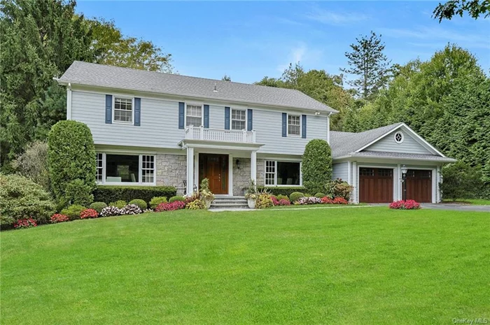 Classic and picturesque Center Hall Colonial situated on a stunning and serene half-acre in the Grange Estate area of Greenacres. Lush, sprawling lawns, mature trees, and evergreens offer a private and tranquil location. An ivy-covered stone wall at the front of the property adds to the charm. The thoughtful floor plan provides an effortless flow. The gracious entry hall is flanked by a spacious formal dining room and an expansive living room, transformed into a casual space ideal for entertaining. The updated and generously proportioned eat-in kitchen features radiant-heated floors, Rutt custom cabinetry, a Sub-Zero refrigerator, freezer/fridge drawers, wine fridge, a Thermador double wall oven, and a five-burner gas stovetop, perfect for the family chef. The breakfast area has sliding doors leading to a fabulous bluestone patio with a built-in Lazy Man BBQ (with direct gas line) and a large private yard, perfect for hosting get togethers and for play. Adjoining the kitchen is a spacious and bright family room with a wood-burning fireplace, built-in shelving and seating, a workspace, and breathtaking views of the property. The first level also includes a private guest/nanny suite with a recently renovated full bath, as well as a laundry room, mudroom with cubbies, and access to a two-car garage with ample cabinetry, a workbench, finished flooring, and enlarged garage doors suitable for an SUV. The second level offers four spacious bedrooms, one currently used as a home office, and a recently renovated hall bathroom with dual sinks and an oversized shower. The expansive primary bedroom includes a dressing room, walk-in closet, and private bath with a double-sink vanity, jacuzzi tub, and separate shower. The renovated lower level is perfect for kids and adults alike, with a large playroom (with yard access) and a versatile gym/media room with built-in surround sound. There is also a full bath and a kitchenette with a second dishwasher, second refrigerator, and sink. Additional interior and exterior renovations (2008-2022) include updated bathrooms, double Cat 5 wiring/Wi-Fi 6, remote app controls for Nest heating/AC, garage access, security system, an 8-zone built-in Sonos system across three levels plus the outdoor patio and select lighting. The home features HardiPlank Siding (never needs painting) and a new hot water heater installed in 2024. A multi-zone lawn sprinkler system keeps the beautiful grounds in pristine condition throughout the season. This welcoming residence, with its breathtaking curb appeal, is a wonderful place to call home. Close to all!