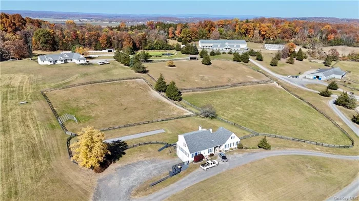 Welcome to a majestic property and a rare opportunity to own a premier equestrian estate in the charming town of Florida, NY. Set on 52 acres of meticulously maintained, picturesque land, this property is designed to cater to all facets of equestrian life, from top-tier boarding and training to breeding and recreational riding. Surrounded by rolling hills, mountains, lush woods, a tranquil pond, and a meandering stream, the property offers both privacy and beauty in a setting equipped for professional use or personal enjoyment. Featuring a total of 32 stalls across two barns, the property boasts cutting-edge facilities with 12x12 matted stalls, rubber-paved aisleways, and enclosed tack rooms for secure storage. Heated grooming bays and wash stalls offer year-round convenience, and each stall is equipped with an electrical box to accommodate summer fans. The barns are thoughtfully designed to ensure a safe and comfortable environment, prioritizing both the care of horses and the ease of use for their handlers. The main barn is an equestrian&rsquo;s dream, featuring an attached 85x200 ft indoor arena with Elite footing specifically formulated to absorb shock to provide a stable, low-impact riding experience. The arena is illuminated by a three-tier window design, flooding the space with natural light, while a heated, elevated viewing room offers a perfect vantage point for guests to observe year-round, in comfort. For outdoor riding, a 120x240 ft arena with excellent drainage provides all-weather access, allowing riders to practice in any season. Additionally, a lush grass field with cross-country-style jumps enhances the training options and encourages riders and horses to explore new terrain and challenges. The property also boasts multiple paddocks, separated by updated fencing, including fresh waterer access and convenient access roads for feeding, as well some wooded trails that can be opened up for scenic rides and endurance training. In addition to its exceptional equestrian facilities, the property offers a range of residential accommodations, making it ideal for family, friends, or staff. The main house, positioned on a gentle hill overlooking the property, features a 4-bedroom, 4-bath Executive Ranch style design with modern upgrades throughout. Vaulted ceilings, an open floor plan, and a full basement with grade-level access create a spacious, comfortable home with spectacular views of the surrounding vistas and pond, which includes a fountain for added ambiance. A secondary house on the property offers four fully renovated apartments in a charming farmhouse style, each with its own deck or private yard space. These apartments provide flexible living arrangements, whether for property managers, trainers, guests, or as rental units for additional income. The estate is completely equipped with essential infrastructure, including four water wells, three septic systems, and a studio apartment within one of the barns, offering living space for staff or guests. Currently operating as a thriving equestrian center, the estate also offers flexibility for alternative uses such as a family compound, wedding venue, restorative retreat, or investment property with potential development options. With a scenic layout designed to be functional yet tranquil, this estate offers endless possibilities for its next owner. With all necessary equipment included in the sale, new owners can seamlessly continue operations or transform this property to suit their vision. Contact us today to explore this unique and breathtaking property and take the first step toward creating your equestrian or personal retreat dream.