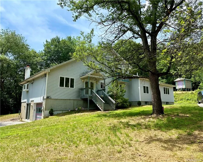 This spacious 4 bedroom, 3 bath home is situated on 18.6 acres offering privacy and relaxation. Trails for hiking or riding an ATV for your own entertainment, a 2 stall barn with electric, a chicken coop and shed . This home has plenty of space and comfort including a primary bedroom with on suite, walk-in closet on the second level and its own lounging area for reading or to use as an office. Plenty of light on the main floor with an open concdept kitchen/living room and cathedral ceiling, formal dining room,  an additional kitchen, living room, bathroom and bedroom on the first floor for family or additional income. Updating needed to create your own oasis!!