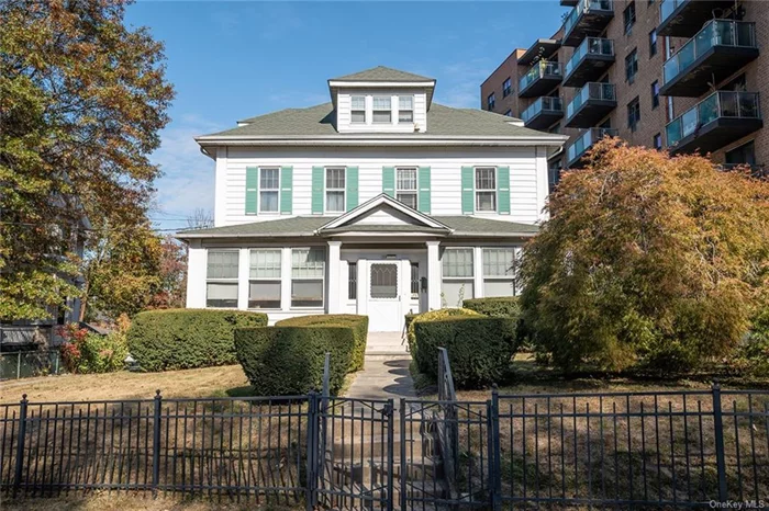 LUDLOW LEGACY - Nestled in the sought-after Ludlow Park neighborhood of Yonkers, this stunning 1915 residence embodies character and versatility, all within a mere 15 minute drive to NYC. Situated just moments from the Hudson River and the Metro North Train Line, 133 Valentine St, Yonkers, NY offers a blend of convenience, historical charm and modern function, with income rental potential as a legal two family, or a grand single family residence with bonus apartment for in-laws. Spanning over 3, 000 SF, 133 Valentine St includes five spacious bedrooms, two full bathrooms and boasts original architectural details that add a timeless appeal. Immaculate hardwood floors, intricate crown moldings, dramatic ceiling heights, exposed beams, period light fixtures, and two fireplaces lend sophistication to the home&rsquo;s inviting ambiance. The flexible layout is perfect for owner-occupants seeking a mother-daughter setup or for those interested in rental income from the legal one bedroom apartment. The heart of the home, the eat-in kitchen, is well-equipped with a butler&rsquo;s pantry and an island, ideal for cooking and entertaining. Butler&rsquo;s pantry offers a nice space to convert for a full bathroom on first floor. A formal dining room sets the stage for memorable gatherings, while the expansive 300 SF enclosed front porch is perfect for enjoying morning coffee or unwinding with a book. Generous large windows throughout fill each room with abundant natural light, creating a serene and calming atmosphere. For those working from home, multiple spaces on the main and second levels offer versatility and privacy. The grand main foyer welcomes guests with a stately feel, and the massive basement provides ample storage or can be transformed into a workshop or additional living area. The apartment includes a bedroom, full bath, kitchen, washer/dryer, and living room, making it self-sufficient for friends or tenants. Outside, the gated property showcases mature landscaping that enhances the home&rsquo;s majestic appeal, along with a detached 2-car garage and a peaceful backyard. Yonkers, known for its rich history, vibrant arts scene, and riverfront parks, offers residents a lively urban atmosphere with the comforts of a suburban lifestyle. With close proximity to both outdoor recreation and city amenities, Yonkers is ideal for those seeking a blend of culture, nature, and convenience. This property is a unique find that combines elegant details, versatile living spaces, and a prime location, perfect for those searching for both comfort and opportunity in a charming, historic neighborhood.