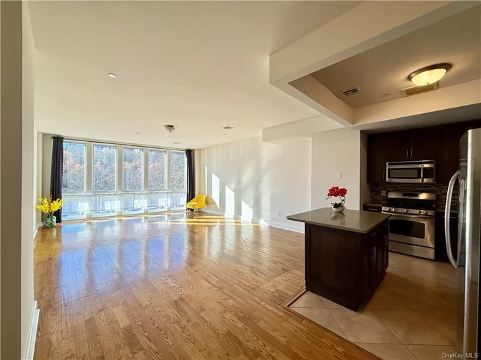 Located in the Accolade Condominium and just 5 minutes from ferries to Manhattan, apt. 2G is a west facing 890 sf studio with a wall of windows, high ceilings and wood floors. With open views, bright afternoon sun shines in all day. Kitchen and island have wood cabinetry with stone counters and SS appliances. The Marble accented bath has a separate shower and Tub, extra counter space and storage. Storage is abundant, there are 2 WIC&rsquo;s plus another storage/utility closet. W/D, CAC and 1 parking space is included. The building has a PT concierge, pkg collection, a lounge, catering kitchen, billiards, foos ball and ping pong tables, golf simulator, gym and more. The community offers Tennis courts, BBQ areas and more. Call for an appointment. Condo Board application required.