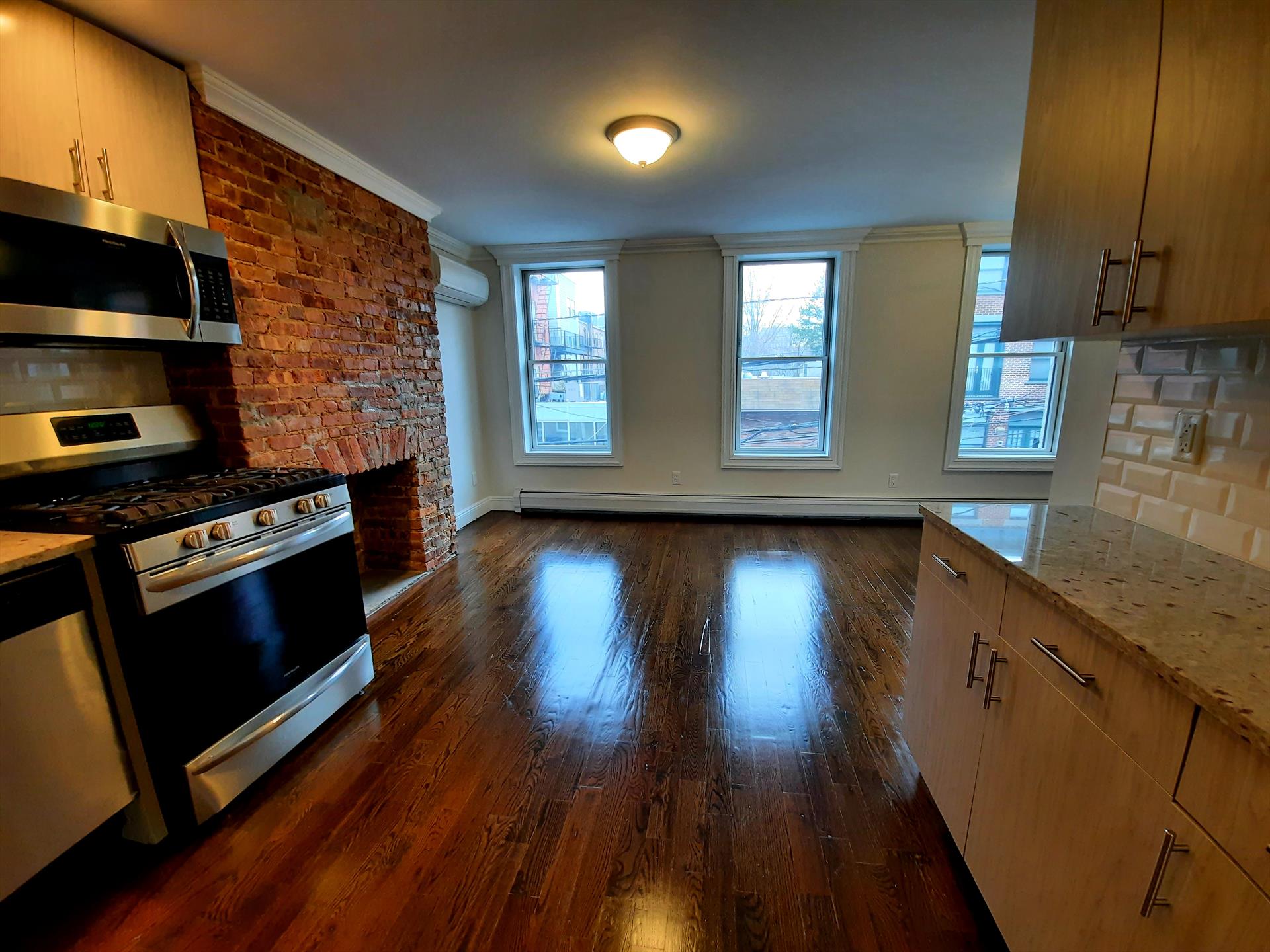 Move into this renovated Midtown Hoboken 2 BR rental located close to the waterfront. Features: great natural light, hardwood floors throughout, modern kitchen with granite counter tops, stainless steel refrigerator, gas stove, microwave, and dishwasher, living room with exposed brick, two bedrooms with closets (BR1: 9.4' x 10' / BR2: 8.4' x 7.7'), full bathroom with bathtub, private washer / dryer, common yard, conveniently located close to restaurants, retail boutiques, the waterfront, parks, pubs, and public transportation to NYC. Tenant pays their own heat, hot water, gas, and electricity. AVAILABLE APRIL 1st or sooner. NO PETS. To make this great rental yours: $3528 (1st months rent), $5292 (security deposit), $3528 (broker fee), $65 credit check per adult. 