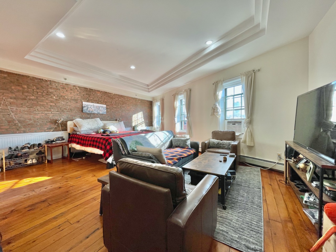 Located on Newark Ave near the Grove St Path station and the Downtown JC Pedestrian Plaza, this 1200 sq ft loft-like home with high ceilings and skylights, offers two bedrooms and two full bathrooms, plus an entrance foyer. Great layout for working from home! The front bedroom is a dramatic 22' by 21' room with exposed brick and three south facing windows with original wide-plank hardwood flooring. The rear bedroom has an en-suite bathroom, and the second full bathroom is off of the living room next to the washer/dryer closet. The kitchen has an abundance of cabinet storage, granite countertops with dining bar, and stainless steel appliances including dishwasher, gas stove, and built-in microwave. The layout works well as either a true 2 bedroom, or a huge 1 bedroom with a separate living room and dining room. Ask for the Virtual Tour!