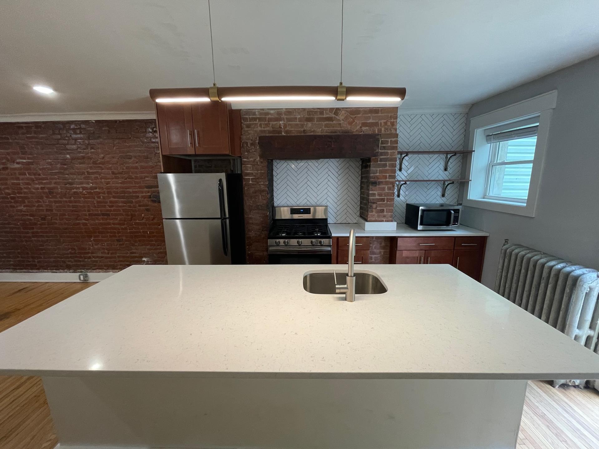 LANDLORD PAYS FEE! Welcome home to this spacious 1 bedroom layout! Unit features: exposed brick, hardwood floors, granite countertops & stainless steel appliances. Available June 1st. Backyard will be completely cleaned up with a new fence installed.
