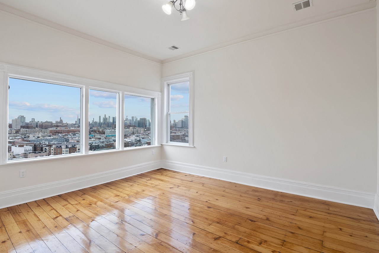 Newly renovated home with TWO CAR PARKING INCLUDED on the east side of Ogden Ave, the best location in Jersey City Heights! A blend of classic historic details with modern, newly installed finishes. Refinished hardwood floors, baseboard and crown molding. Original closets redesigned to accommodate hangers. Spacious rooms with high ceilings. Central Air for heating and cooling. Full sized front loading washer/dryer in unit. Kitchen with tall white shaker cabinets, quartz countertop and matching quartz backsplash. Built-in microwave and gas range/oven. The four bedrooms and living room are interchangeable as they all have doors and closets. Amazing NYC view from the rear room and the kitchen. Two car (tandem) parking included. Available ASAP!