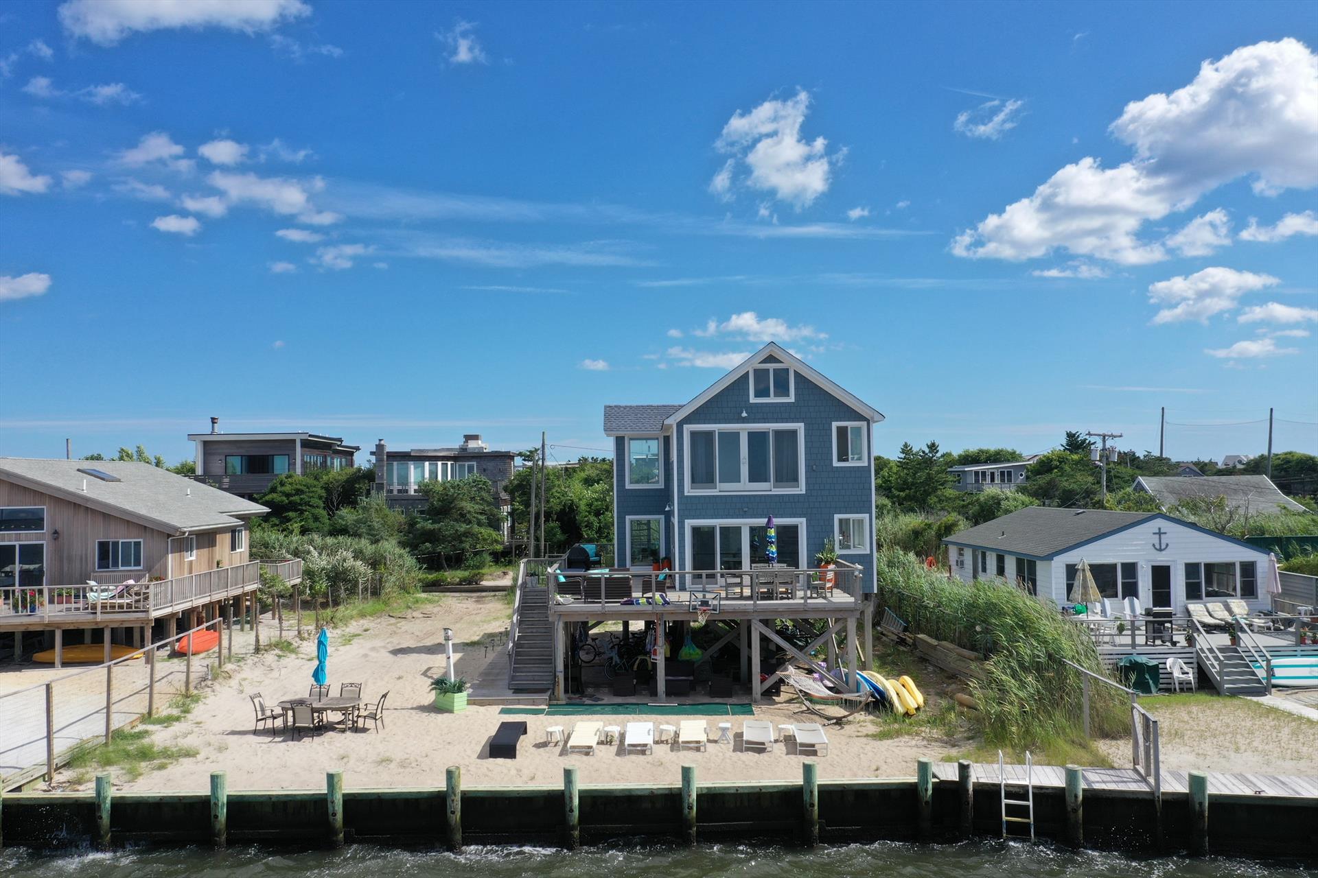 Located right on the Bay in Ocean Bay Park, this house was completely renovated in 2023 from top to bottom, inside & out! This home provides all you need to enjoy your stay on Fire Island!  Spacious deck allows for plenty of outdoor entertaining, dining and sunbathing with epic bay views.  You can easily spend the whole day here with your own private beach area below complete with outdoor shower, chaises, kayaks and more! Stay cool & comfortable with ductless AC throughout. 
<br>
