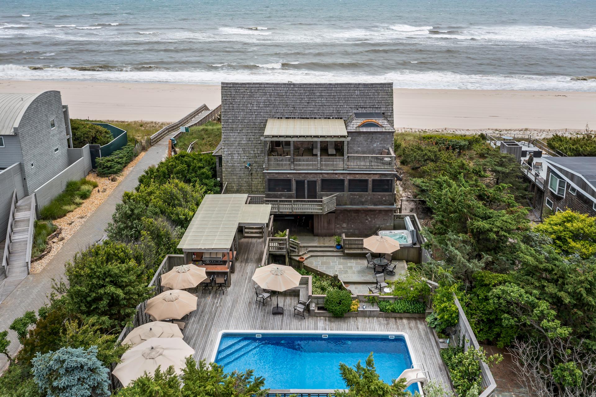 This spectacular 3 level oceanfront residence boasts over 3,100 SF of living space.  Enjoy breathtaking panoramic beach views in Fire Island's most coveted location.  With 7 bedrooms, 3 full baths, and 3 half baths, this home can comfortably accommodate extended family and guests.  Situated on an enormous parcel, the 160' X 100' lot is more than 2.5 times a standard size parcel.  Extraordinarily rare opportunity to own a property of this size on the beachfront.  This highly coveted property is an entertainer's dream with a large swimming pool, hot tub, outdoor kitchen, game lounge, screened in porch, and multiple decks.  The upper level features a private and luxurious primary bedroom with en-suite bathroom, and private balcony, as well as a spacious office space, all with sweeping beach views.  