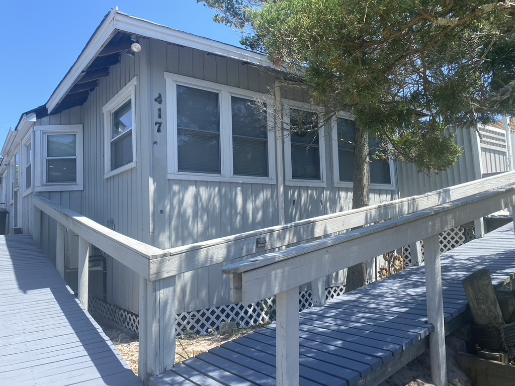 This home features 4 bedrooms and 3 bath rooms! A sunny south facing deck makes perfect for hanging out and getting some sun or having a BBQ after a long day at the beach. This home is just steps from the beach. 

