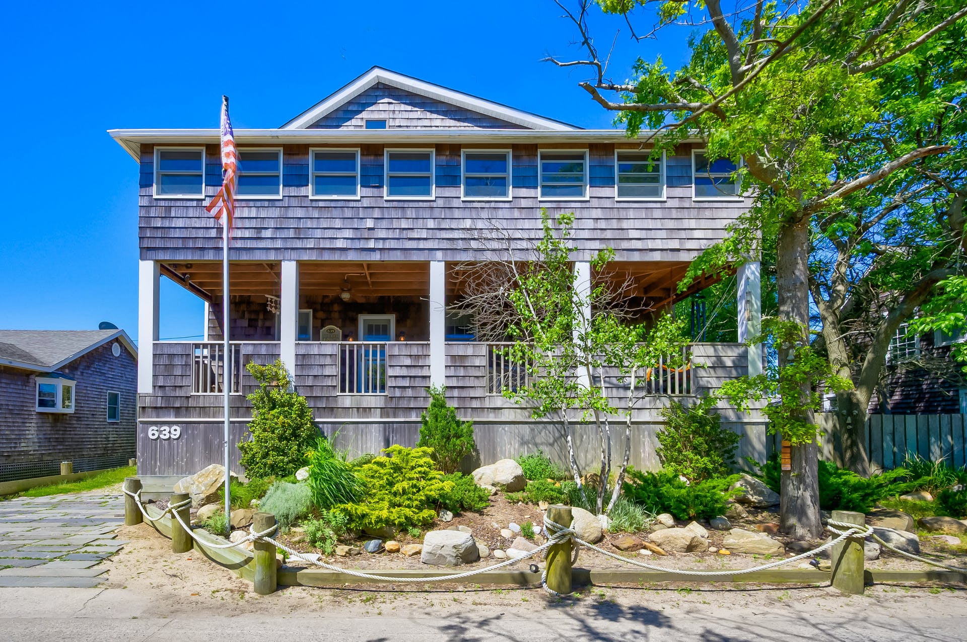 This classic coastal-themed beach home is the only of its kind available to purchase.  It’s ideally located on Ocean Beach, Fire Island - just mere steps from authentic restaurants and boutique shopping and walking distance to the most breathtaking beaches. Enjoy your freshly brewed coffee on the cozy 3-season front porch with peek views of the bay or relax in the oversized 2nd story sunroom. The first floor features hardwood floors, a large living room, updated kitchen with granite countertops and plenty of cabinets, and a meticulously renovated bathroom. Adjacent to the open living area, the formal dining room is home to a beautifully handmade coastal-themed dining set and built in cabinets. The second story boasts 4-spacious bedrooms, all with great closet space. Skylights flood the massive master bedroom and ensuite bathroom with an abundance of natural light. The lush, native foliage and fence create a private oasis in your own backyard - perfect for entertaining. Enjoy it as is or potentially add a pool! Keep cozy during the winter months with the wood burning fire place and develop deep connections with fellow year-round Fire Islanders. This is one of few fully winterized homes on Fire Island! If additional storage is needed, this home has plenty of options including the standing garage/storage area and attic. This immaculate sun-drenched colonial home has been occupied and cared for by the homeowner for more than 30 years. This home has been thoughtfully named Tucked Inn, after the 20-foot Narrasketuck sailboat that the owner and his family used to race. Now is your opportunity to become the next homeowner and make everlasting memories here. When you’re not personally enjoying this beach oasis, take advantage of the HUGE investment potential in the luxury vacation rental market. This is one of the few classic Fire Island homes with a lot size large enough to potentially add a pool left on the market and it will not last. All the furniture is included to make your move here seamless and easy. Affordable flood only $650/YR