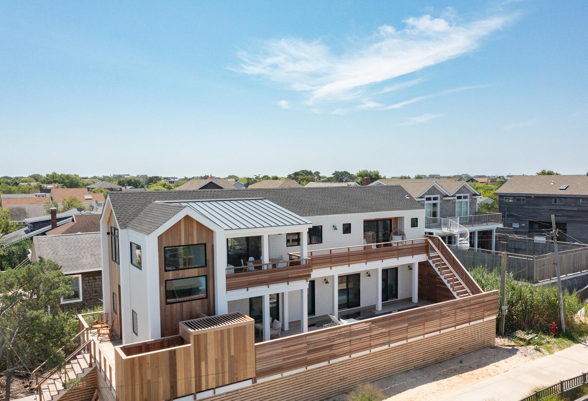 Just completed, this ground up new construction home is the beach house you have been waiting for! Designed to maximize the sweeping views of the Great South Bay, this stunning new build is located on one of Ocean Beach’s most desirable blocks. Situated on an oversized 50’ X 104’ lot, the property boasts over 2,000 SF of living space, including 4 bedrooms and 2.5 bathrooms. Designed for durability and easy living, the home features low maintenance Hardie shingle siding with mahogany accents, mahogany decking, Andersen 400 windows and ceramic tile flooring throughout. Central heat and air conditioning will keep you comfortable in all seasons.
<br>
The first floor has three bedrooms, including a junior primary suite with his and hers walk-in closets, and a convenient laundry room and mud room area with an extra refrigerator. The pool deck has direct access to the hall bathroom so no need to worry about wet bathing suits tracking a mess through the house.
The second floor impresses with an open great room with vaulted ceilings, oak beams, and a chef’s kitchen featuring a custom wood hood, Bosch professional appliances, waterfall edge island, and a large pantry, as well as a powder bathroom and the primary suite. The primary bedroom features ample room for a king bed from which to enjoy bay views, a spa-like ensuite bathroom, a walk-in closet and sliders to the second floor deck with stunning views. Enjoy breathtaking sunsets over the bay while entertaining on the second-floor covered eating area, complete with a deluxe outdoor kitchen. Exterior steps lead down to the spacious pool deck for seamless entertaining flow.   A heated saltwater pool and sunny decks maximize outdoor enjoyment while offering stunning bay views. You’ll enjoy rinsing off in the beautiful mahogany outdoor shower after a great day at the beach.  Ideally positioned on a quiet corner on a low traffic street of Ocean Beach, this home combines serenity with accessibility, offering a quiet retreat just a short walk from town. Sold fully furnished, this stunning home is ready for you to move right in!