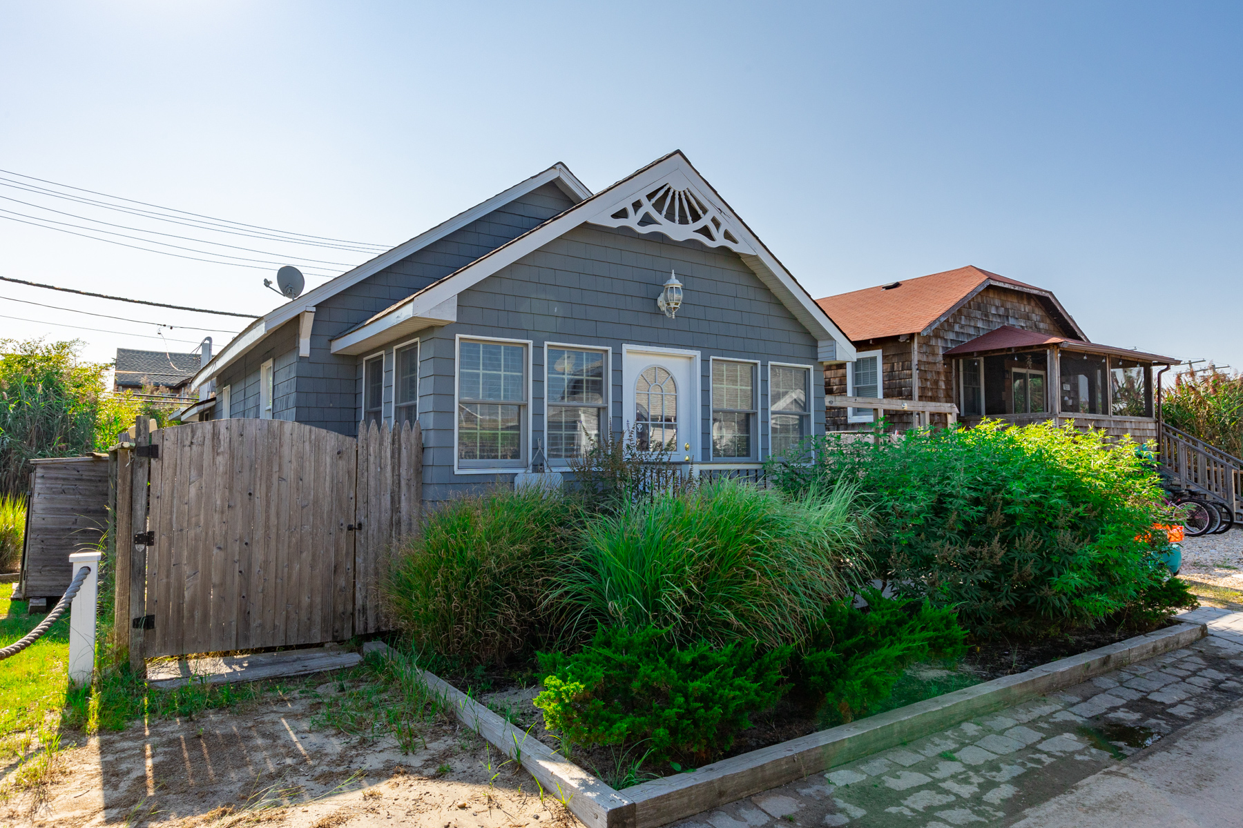 956 Surfview Walk, Ocean Beach
<br><br>
Welcome to your beach oasis at 956 Surfview. The wonderful main house features open style living with a bright open kitchen with peninsula and stools overlooking large expandable dining table. The living room has two couches, a built in Bench with tons of storage. Sunny front sunroom that sleeps four comfortable. Full bath with full size laundry and large storage closet. Out of the kitchen sliders you can enjoy the sun on the brand new composite deck with lighting. Off the deck we have a separate bedroom with private bath, Outdoor shower and large storage closet.