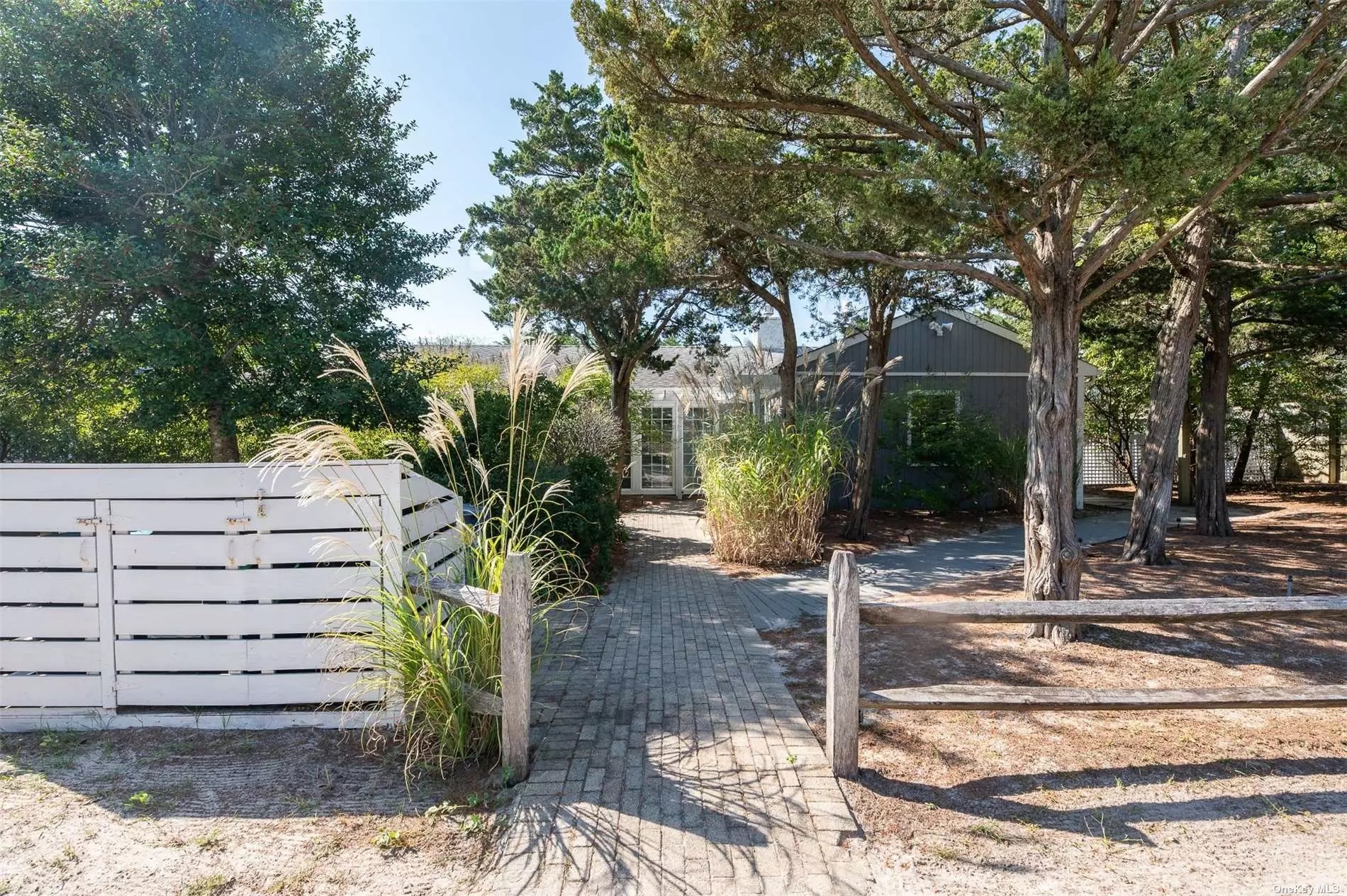 Welcome to the exclusive Summer Club on Fire Island! This expansive wide-line ranch offers the ultimate beachside retreat, featuring an inviting entry foyer and a spacious open floor plan that seamlessly connects the living room, dining room, and kitchen. With four bedrooms, two full baths, and a separate laundry area, this home is perfect for comfortable living. Step outside to a large deck, ideal for entertaining, complete with an outdoor kitchen, hot tub, and shower-all just steps from the ocean. Situated on a rare double lot with mature landscaping & plenty of property to add a pool, this private oasis is in turnkey condition. Enjoy the community’s clubhouse, equipped with a gym, tennis courts, ping pong, shuffleboard, a pool table, darts, and moorings for your boat. The perfect setting for hosting private parties and making unforgettable summer memories!