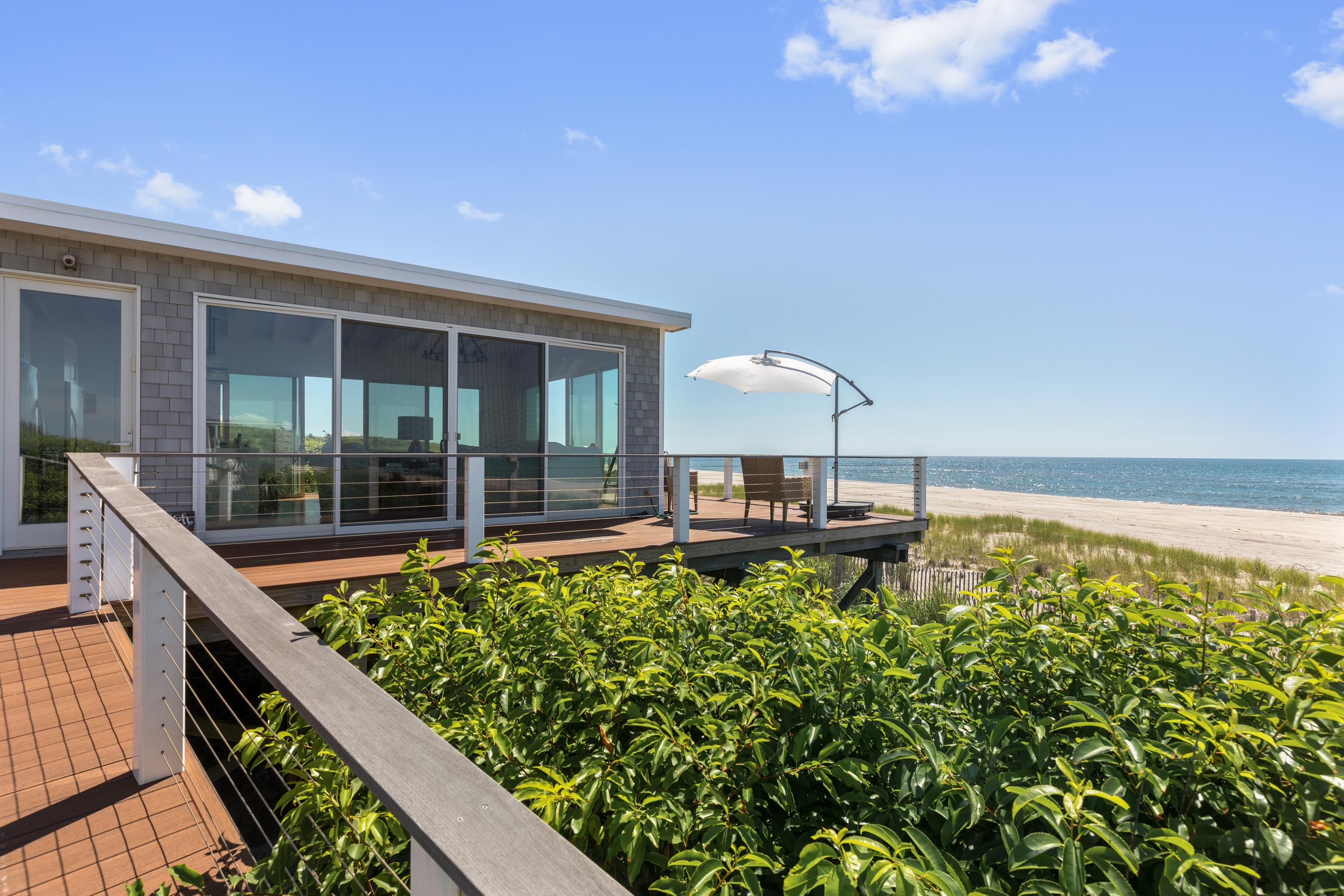 Impeccably renovated from top to bottom, this beachfront residence boasts panoramic Atlantic Ocean views, 3 bedrooms, 2 bathrooms, and a spacious wraparound deck. Located on the eastern end of Fire Island, in an exclusive enclave of Water Island, this one of a kind home offers the utmost privacy, peace, and quiet in a truly spectacular setting.  If you're seeking a quiet place to relax, look no further.  With lush vegetation and National Seashore Preserve lands to the east and west, you will enjoy the majestic views and natural setting at this special property. The open great room features 3 walls of glass through which to take in the mesmerizing views, a brand new high-end kitchen, vaulted ceilings, and designer furnishings.  The luxurious ocean view primary bedroom features a beautifully appointed en-suite bathroom, high ceilings, ample closet space, and direct access to the deck. Enjoy the stunning, never crowded beach directly in front of the home, or walk a short stretch down the sand to the lifeguarded area of Barrett Beach.  Also included is private boat transfers from the mainland to the house via the private dock shared by the 4 homes in the community.  This incredible retreat is less than 60 miles from Manhattan, 1 mile from the Fire Island Pines, 1.5 miles from Davis Park, and only a 15 minute boat ride across the Great South Bay from Sayville.<BR> <BR> 

