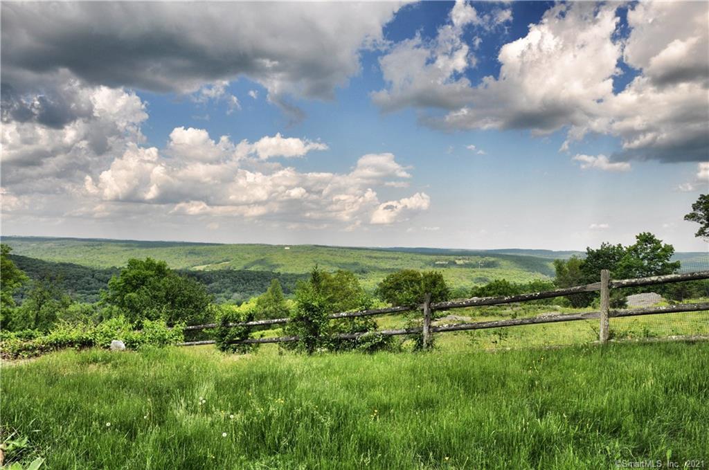 Views, Views, Views!! The best views in all of Woodbury. Long distant views from the hilltop off of Hoop Pole Hill Road. Enjoy the breezy summer nights on your stone terrace next to your vanishing edge gunite pool with jacuzzi. 5-acre plot with a level house site and privacy from your neighbors. Light and bright contemporary home with a wall of glass to take in those sweeping views of Litchfield County.  Amenities provide 4 to 5 bedrooms and three full baths, generous sized dining room overlooking living room with 24' soaring cathedral ceiling and a wall of glass. Recently refinished oak flooring, paint inside and out and finished lower level, an ideal spot for an in-law suite. Beautiful outdoor space with spacious yard, privacy from neighbors and room for outbuildings or expansion. Million dollar VIEWS for less!