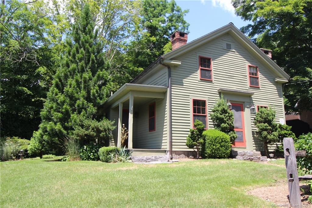 Long coveted Hotchkissville home (a village setting within historic Woodbury CT) Restored w detail by a local craftsman. Enchanting, charming, & period details are some of the initial words you will use to describe this home. Low maintenance, mechanically updated, & affordable living are others! Perennial lined, stone and split rail fenced front yard, huge stepping stones, sweet side covered porch off the dining room. Family side entry welcomes you into a stone floor mud room with a built in granite stone bench. It could not get any more charming UNTIL you see the wonderful glassed eat in alcove, the fabulous, tasteful & timeless kitchen. Hidden behind the paneled wall is the pantry & laundry a surprising modern amenity for 1840.  Enter into the dining room (all rooms offer the plaster finished walls & gorgeous wide board flooring) Lounge on the side porch before or after dinner. The living room showcases a detailed fireplace mantel, paneled walls line the stair case & built-ins make this an efficient and charming blend of a quiet calm for friends and family to enjoy. Master suite with vaulted, beamed ceiling, full bath, 2 walk in closets and hook up for wood stove. Two additional pass thru BR's. Dont let the acreage fool you-from the kitchen alcove, you overlook the neighbors gracefully maintained meadows & red barn, but you do not pay taxes on the vista! Cannot get any sweeter than this for a minimized country life. Viessmann furnace, newer roof, CAIR on 2nd level.