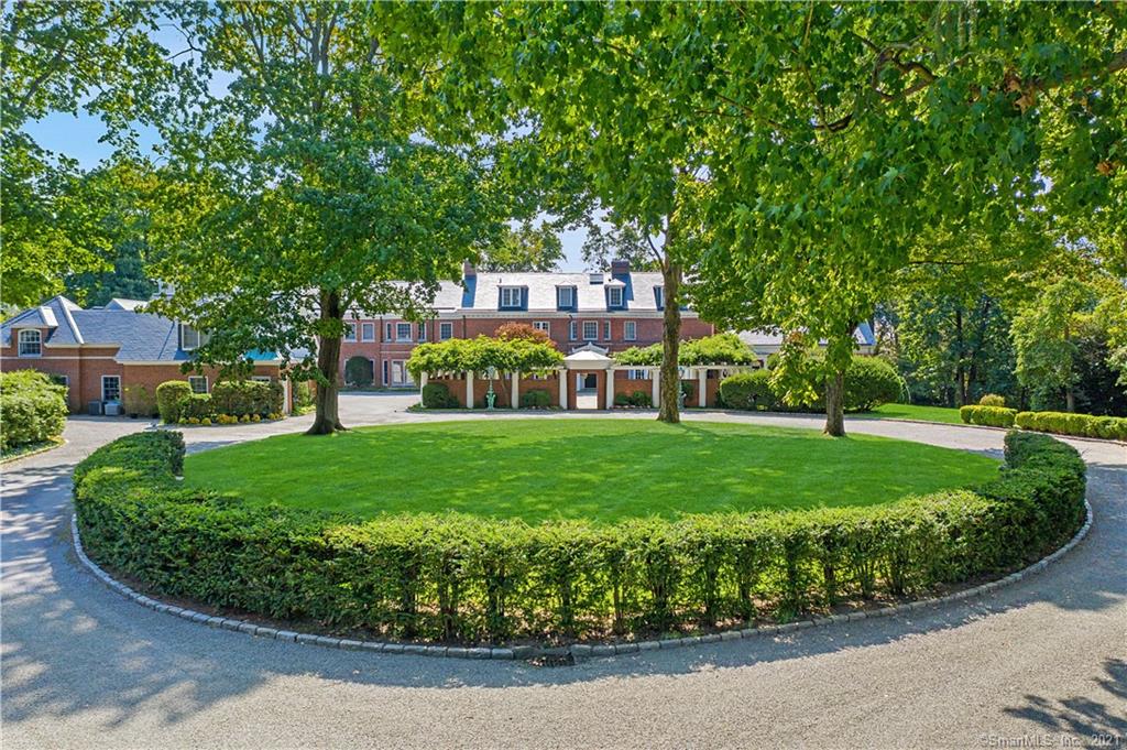 Remarkable Belle Haven Classic Georgian Colonial with only 2 previous owners. The estate sits on almost 6.4 acres. 2, 1 acre lots have been subdivided thus able to create a compound in addition to the guest house and cottage flanking the driveway. A brick walled inner courtyard leads to the front door. Grand center hall with fireplace and wood paneling opens to a columned terrace overlooking the beautiful property. It was built in 1900 and enlarged over the years with the largest addition in 1991, nearly doubling the size of the home. The magnificent library features a doorway and details from Grosvenor House, London. Formal dining room with marble fireplace. Living room has raised wainscoting, original murals and a marble fireplace as well as french door to a covered terrace. 2nd fl has a grand master suite as well as 6 bedrooms. A unique property with unparalleled privacy and beauty.