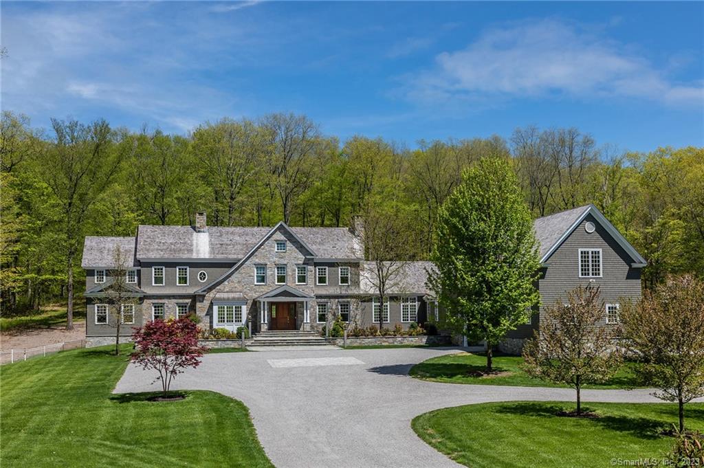 Stone Bridge. The Ultimate Classic Country Estate with Modern Amenities. Impeccable Stone and Shingle home, set on 24.9+ private bucolic acres in the highly desirable Nettleton Hollow area in Washington, CT. Elevator to all Floors. Architect-designed and built by HOBI Award Winning, Corbo Associates, this 7000+ sq ft, with additional finished 3100 ft on the lower level is graced with 5 bedroom suites, including first and second floor master suites, state of the art easy care systems and heated gunite pool. The public spaces open on to terrace and covered patio space to bring the outdoors in. Garaging for 3 cars via porte cochere to a second garage. Privately set off the the road with a meandering driveway which overlooks a nearby pond, the elegant and comfortable spaces throughout flow from house to patio and pool. Soaring ceilings and glass bring the outdoors into every room. Sprawling spaces for entertaining with 7 fireplaces, elevator, library, home theater, game room, 1500 bottle wine cellar and tasting room, sound dampened walls, generator, central vacuum, home technology and security system. A top of the line kitchen is the center of the home with an additional butler's kitchen for entertaining. Top rated construction and energy efficiency, using state of the art geothermal heating and cooling system and Cat 6 audio wiring for sound, data and internet. The manicured grounds with mature plantings and stonework include an irrigation system. Magnificent Country Estate!