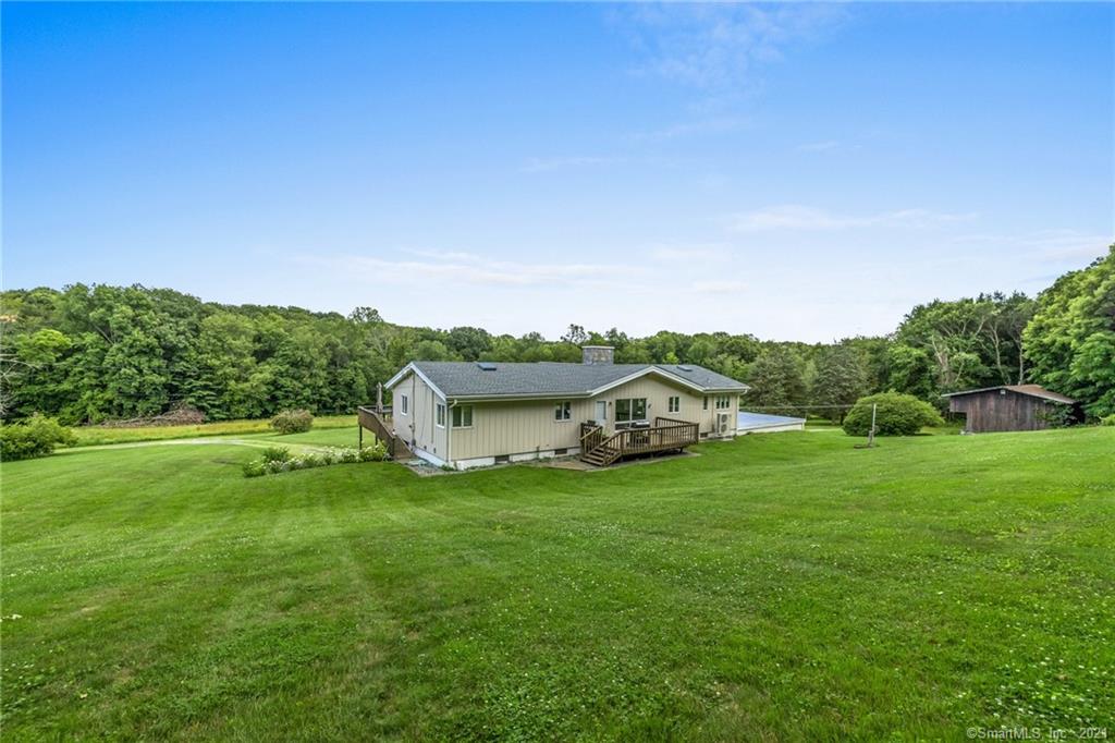 This remodeled contemporary is located in the pastoral Grassy Hill section of Woodbury. The property features a large yard and additional open meadow space, allowing for great country views to be enjoyed from the expansive deck. A recently renovated main level consists of an open floor plan, highlighted by the oversized stone fireplace. The sunken living room has hardwood floors and a large projector screen for relaxation time. The kitchen features vaulted ceilings, soapstone counters, a chic natural stone slate floor, and access to the back deck and grill. Beautiful views are to be had from the master bedroom with hardwood floors, walk in closet, and a completely remodeled master bathroom. The opposite end of the home consists of two bedrooms and an additional full bath. Downstairs is a large open room for additional living space, a third full bath, and a smaller room which could be used for an at home office setup. Just 5 minutes to Main Street in Woodbury, and under 2 hours to Manhattan.