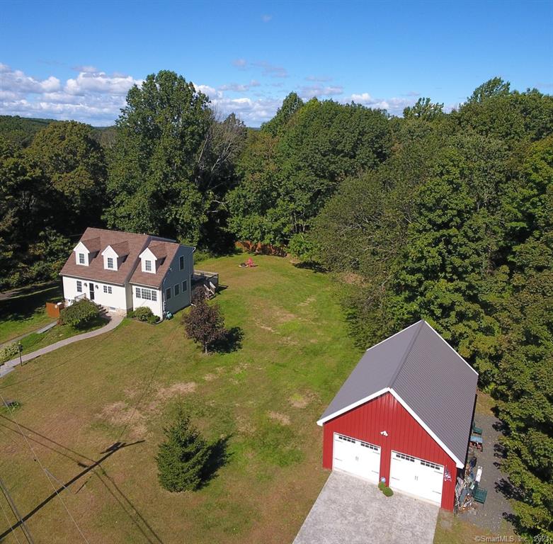 Picture perfect 3 bed 2 full bath Cape Cod on 2 level open acres. Nothing to do but move-in to this well maintained and nicely updated home! Remodeled kitchen with gorgeous wood cabinets and stainless steel appliances. The adjacent dining room is surrounded by glass on three sides including French doors to the back deck. The front to back living room is next to a remodeled full bath. Upstairs there are 3 sunny bedrooms and a renovated full bath with double sinks in a granite topped vanity and tub shower. The detached two car garage is heated with propane. The large yard is beautiful and also houses a nice shed. Recent updated include furnace and central air, oil tank, well pump, water heater and more!