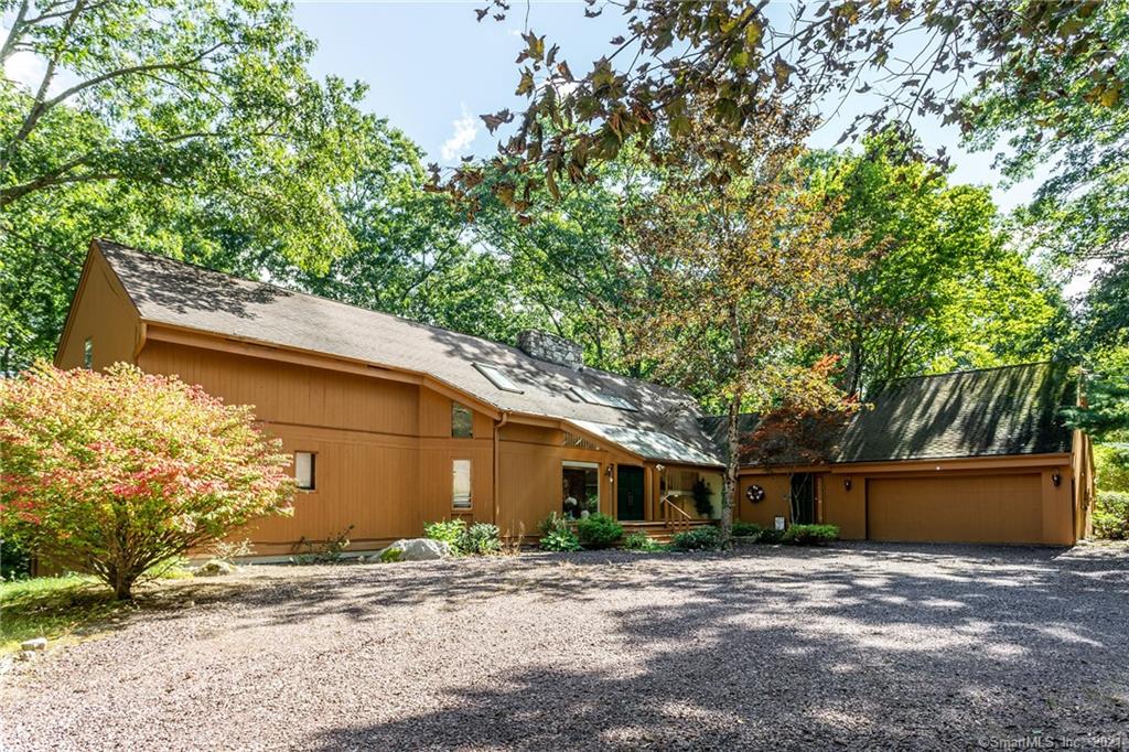 Gorgeous 1980's high quality contemporary with floor to ceiling windows for great natural light..4 bedrooms, 5 baths and five car garage, set on just under 2 acres of open level and lightly wooded land. Modern design elements with grand glass sliders, walls of glass and native stone fireplace which bring the feeling of the outside in! Minutes to both Woodbury Center and Roxbury, this oasis is privately sited on a quiet lane with a long driveway.. Covered parking for 5 cars, with an attached 2 bay and an additional 3 bay garage. The gracious layout with grand public spaces, wraparound deck with access from each room, High Ceilings and a finished lower level with family room or gym are just some of the amenities which make it the perfect getaway. The Master suite is also on the first level with a nearby office/den to make one level living easy. Walk out finished basement, newer mechanicals, A/C and furnaces. This special home is a gem and just moments to Woodbury Center and Roxbury... and only 90 minutes from Manhattan!