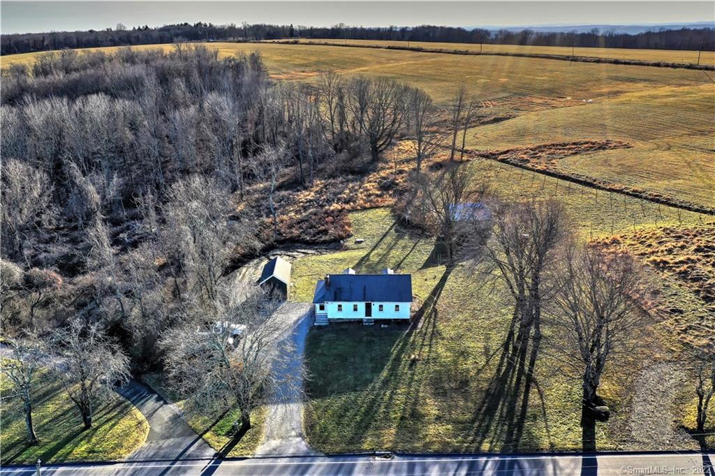 In the most idyllic farm setting sits this 1935 Cape Cod home with 4+ acres. Surrounded by open fields nestled up to the Roxbury land trust with views in every which direction. This property offers a horse barn with two 10x12 stalls, a hayloft and tack/ feed room; also a 12x24 barn for storage of equipment etc. The interior of the home features a spacious feel, hardwood floors throughout the main floor and a great deal of natural light. Along with the 1 bedroom is also a decently sized den that could be used for whatever your heart desires! There is a partially finished attic that could serve as a massive walk-in closet or storage. With appropriate permitting this home has the potential to be added on to with its 3 bedroom septic. Do not miss out on the chance to own this scenic property with the opportunity to bring your horses home to your own backyard! Agent is related to seller.