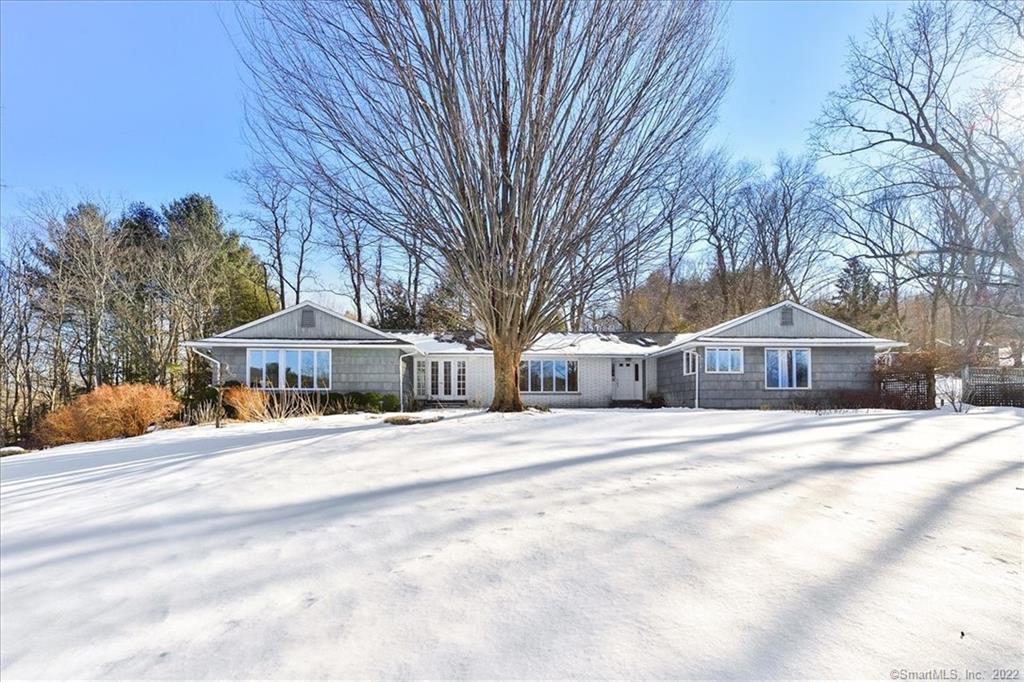 Let the sunshine into this impressive Ranch style home with awesome long distance views especially enjoyed from the 25'x23' family room with galley kitchenette, full bath, french doors leading to a welcoming 13'x13 deck and separate entrance. This space can be a possible in-law/guest suite or studio if needed. A fabulous country kitchen with granite counters, cherry cabinets, custom built center island, 2 pantries, skylights and a breakfast nook with french doors to the bluestone patio overlooking the lovely gardens. The living room features fireplace with mahogany mantle, formal dining room with french doors, an office with built in bookshelves and french doors to an inviting 11x7 deck. The spacious Master bedroom suite features a walk-in closet with organizing system, beautifully remodeled master bath with whirlpool tub, spa shower and double vanity sink. Two more generous sized bedrooms and a full main bath with tub/shower, marble tile and skylight complete the west wing. Good-looking wood flooring through the main living area. The rear mudroom features Saltillo tile floor and a separate laundry room. Interior access to unfinished basement area that houses the mechanicals and storage area with access to the oversized 2 car garage with lighted workbench space and auto door openers. Located on a quiet county road just minutes from downtown Woodbury with its charming antique shops, restaurants, and parks. Enjoy all this expansive, move-in ready home has to offer.