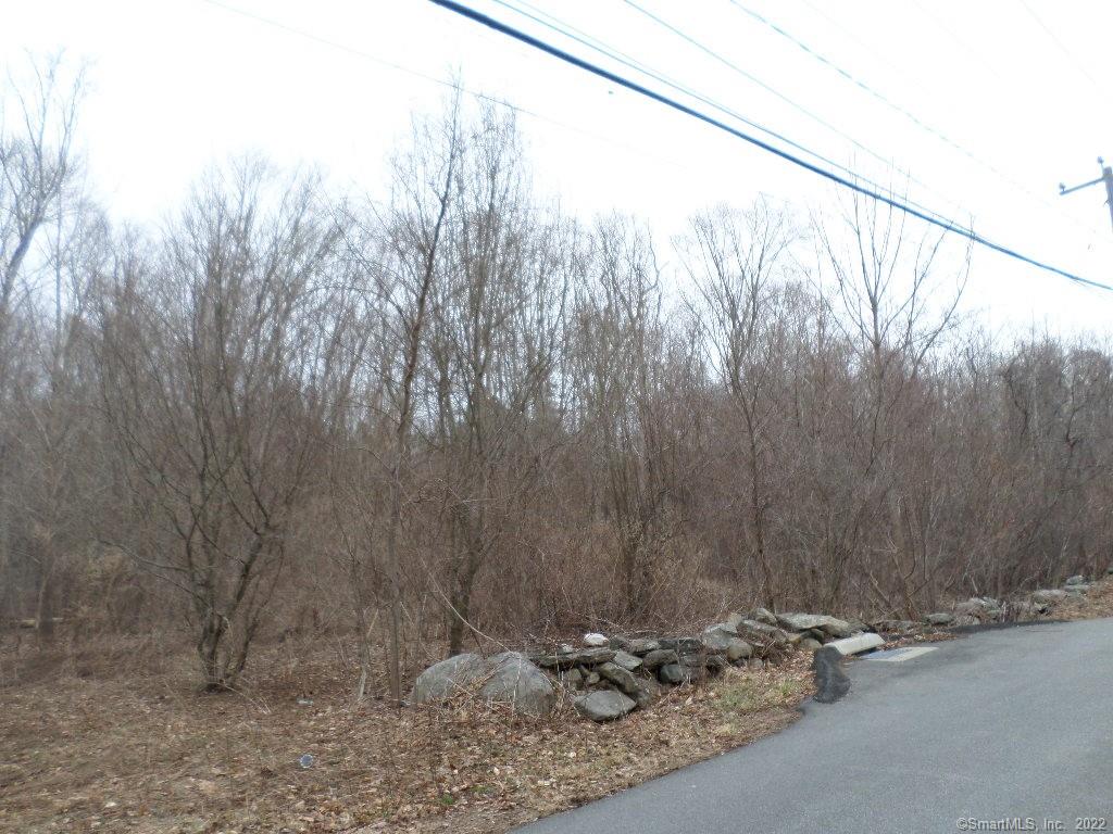 Approved building lot on quiet country road. 1.3 Acres Stone walls,  lightly wooded