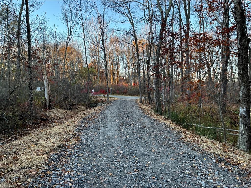 Beautiful new access road has just been completed! Additional 14 added to driveway with some spots as high as 18-20 for proper drainage. Also replaced existing drain with a new plastic pipe under the driveway. This work has transformed this lot. Build your private getaway on 10.56 acres of woodland located between the two quaint New England towns of Kent and Warren in beautiful Litchfield County. Private and pristine. There is an easement on this lot to the adjacent lot (184 Kent Rd., Parcel A) Kent Rd. is a main road but the lots are long, fairly level and deep so the building site could be situated well off the road. There is 150 feet of road frontage. Close to shops, restaurants and Lake Waramaug!