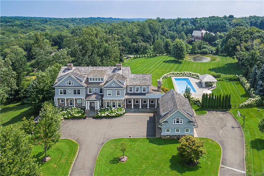 Welcome home to the prestigious Oenoke Ridge area of New Canaan. Set at the end of a long private drive, this sun-filled 12, 000sf home was custom built by the award winning team of Gardiner & Larson. Located within minutes of town, Oenoke Manor is a four acre estate that exudes luxury, yet with a casual lifestyle perfect for both everyday living and executive entertaining. The grand entry opens to the formal rooms and invites you onto the covered porch for outdoor relaxation and sweeping views of the back gardens. French doors from chef's kitchen and oversized family room lead to a stone terrace for outdoor dining near the pool and pavilion. The primary suite boasts his and hers baths as well as dressing closets for each. An exercise room with a steam shower is adjacent to the master. All bedrooms are en suite. The finished lower level is the perfect place to relax or entertain friends. The home offers both a formal office in the main living area and separate guest or au pair quarters above the garage that would serve well as a second private office. This professionally landscaped enclave is a quiet retreat with easy access to all that New Canaan, a wellness-centered community, has to offer, a thriving downtown of gourmet restaurants and boutique shops. Recreational facilities include New Canaan's Waveny Park with 300 acres of jogging trails and sports' fields. All this within easy access to NYC. Please do not drive onto property. Children at play.