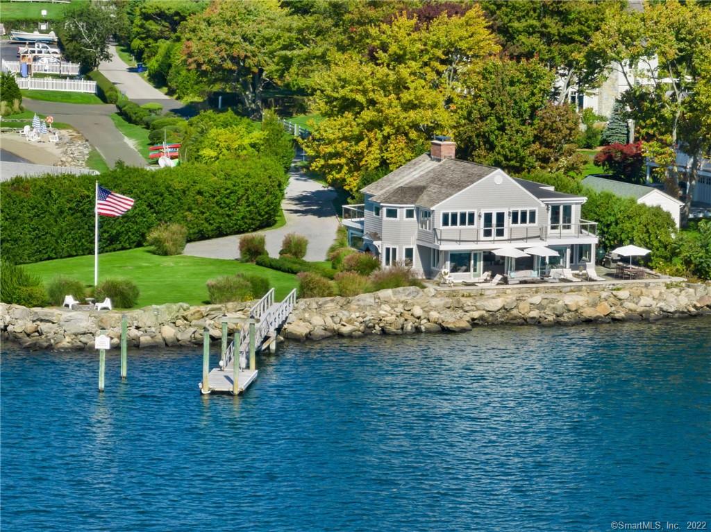Unrivaled Retreat by the Sea with a 230' water frontage and a deep water dock.Just imagine if you woke up to the sea breeze, sounds and salty water views from every room in the house. This open concept, well designed casual coastal home boasts patios and decks, a well manicured lawn and garden in a private setting on Wilson Point, an enclave of Rowayton. With upgrades throughout, this 4 bedroom/4 bath lifestyle residence has access to a private beach, tennis, social activities and The Norwalk Yacht Club membership. Close to the restaurants and shopping in Rowayton and South Norwalk.A one hour commute to NYC.