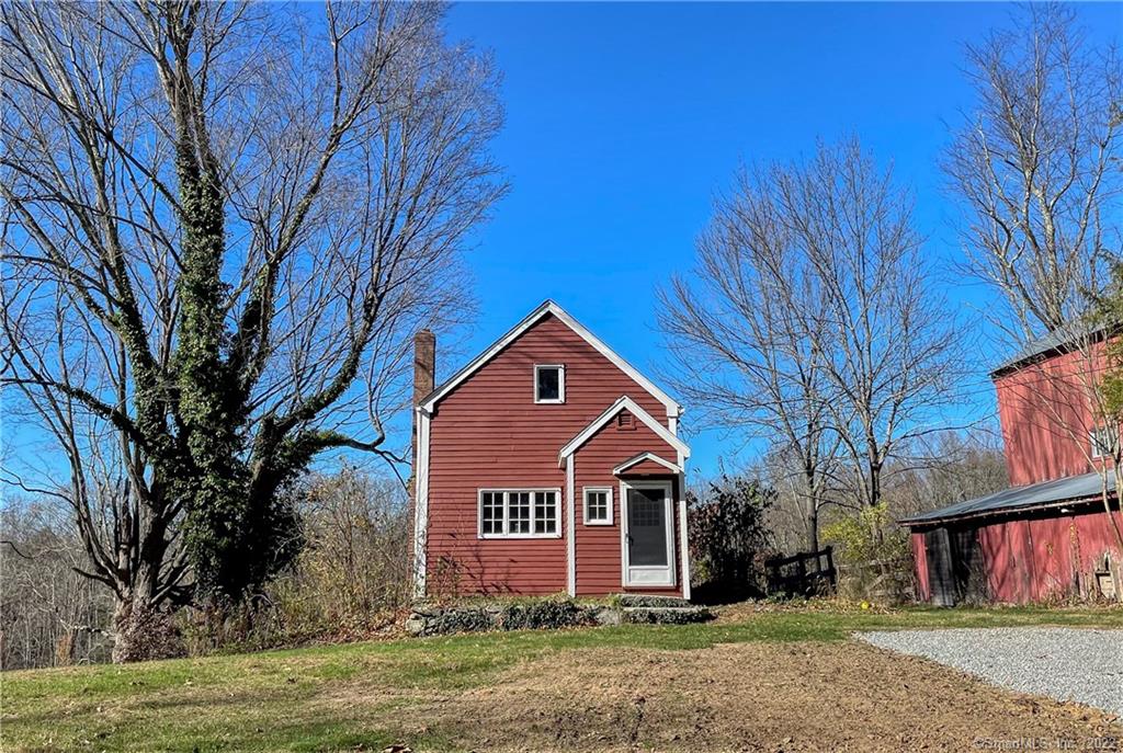 Charming and rustic cottage on estate property close to town. Cozy and comfortable, the house offers wood floors, stucco walls and beautiful exposed beams throughout. The living room and full bathroom occupy the main level. The kitchen with brick floor is in the walkout lower level. There is an island, electric stovetop, new wall oven, new dishwasher, and new refrigerator. All stainless appliances. The walk-out leads to the designated private outdoor space and includes brick patio, overlooks a meadow and has space for a garden. The one bedroom with vaulted ceiling is on the upper level and includes a large double deep closet. Washer and dryer are located in the nook under the stairs in the kitchen. Rental includes landcare, mowing, snow plowing and trash. Tenant is responsible for electric, cable, internet, propane (heat) and renter's insurance. Tenant take cares of shoveling from front door to driveway. One cat will be considered. There are low ceilings. Must have good credit. Barn is not included in the rental.