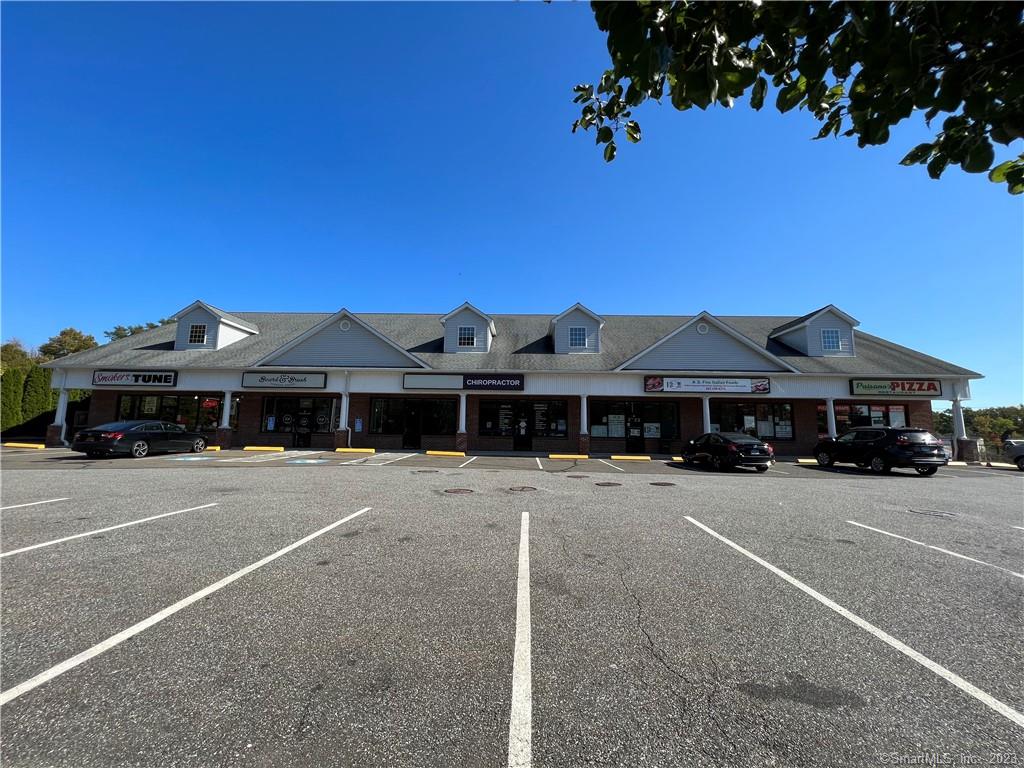 Elm Street Plaza is a busy plaza with tenants that include A&S Fine Foods of Monroe, Board & Brush, Smoke Tune and Dr. Gomez Chiropractic offices. This newly vacant end-cap is available. The lease rate is $17 NNN plus heat/electric & trash. The rent is $1, 865.75 plus the NNN is $6.08 PSF (Taxes, Insurance & Maintenance) is an additional $667.28 per month. Total monthly payment = $2, 533.03. Unit 7 has an open floor plan with a small storage area and restroom. 1 Acre Site, B1 Zoning, 42 parking spaces. The nice brick building with covered walkway makes this a great location for any retail or office use. A&S is a daily draw for customers to shop the center. The center is visible from Route 111 without being on Route 111. The lease rate is bargain for the space. Parking and dumpsters are in the rear of the building. Employees can park in the rear and customers can park in the front. Trash is shared and paid by tenants. Monument signage in front of plaza. Photo of sign shows current and former tenants. A new photo will be placed in the listing shortly to reflect the newer tenants which include Smoke Tune and the Chiropractor.