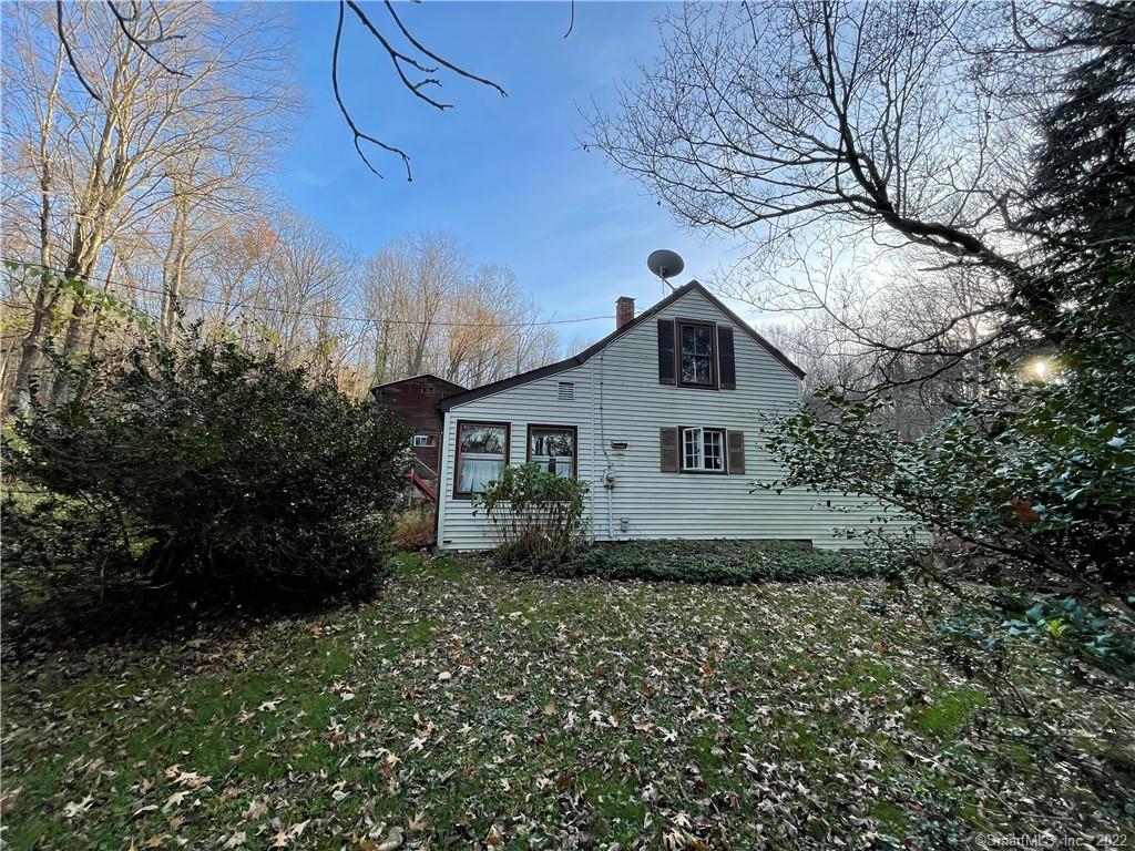 Small cape in need of total RENOVATION. In an Estate and in the process of being emptied. 8.84 acre lot with a small stream running though it. There is a barn on the lot that needs total renovation. You enter the main level through a rear porch into a living room with a wood stove. In the back there is a kitchen that goes out to a 3 season porch. Also on this level is a bedroom, laundry and a full bath. Upstairs there is a bedroom and a sewing room/den. Will Not Qualify For FHA mortgage. Need Conventional or Cash! Sold AS IS!