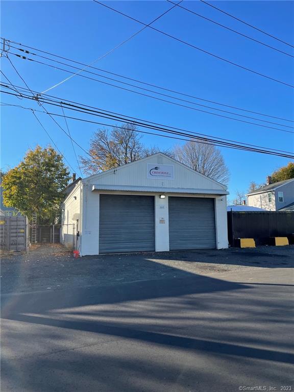 Industrial Building - Was truck maintenance building with high overhead door.  Excellent office space on two levels. There is more square footage in this building than on the city records with the second level. Nice conference room, kitchenette, offices, two lavatories, storage area. Nearly impossible to find buildings as good as this one.  Excellent condition with recent electrical upgrade and newer roof.  Outside storage or additional parking on the left side of the building. Number 69 Carroll Ave. also for sale. Heat and Central A/C (2 Units) are electric. Gas meter on side of building.  Three Phase electric is available. Interior furnishings are for sale for $10, 000 including camera systems, furniture, flat screen TV and more. Two overhead doors. Behind one door is now a conference room - could be opened up. Building also for rent for one or several years $2, 800/month plus utilities and tenant insurance. Owner pays taxes, insurance, and major maintenance. Available quickly.