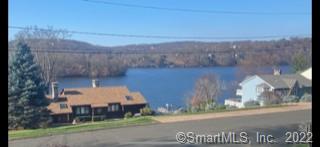 ENJOY CHRISTMAS AT THE LAKE WITH BEAUTIFUL LAKE VIEWS situated on the most desired PRIVATE lake community Candlewood Lake Shores! Lake access to fishing, boating, kayaking, boat launch/mooring right up the block on Candlewood Shores Road, Dock available for additional fee. FEATURING: Western exposure with beautiful sunset, access to a private beach, park, playground/Tot lot, basketball and volleyball courts and more. Boat/ mooring is available for an additional charge of $3, 000. Covered front porch with views of the lake, wood deck off the kitchen that leads to a manicured fenced in back yard perfect for entertainment and let your dog loose. Interior has vaulted ceilings in the living room with a fully functioning fireplace. Hardwood floors and central air system throughout main level. One car garage underneath with ample storage. Close to I84, route 7, restaurants and shopping. Only an hour drive from NYC