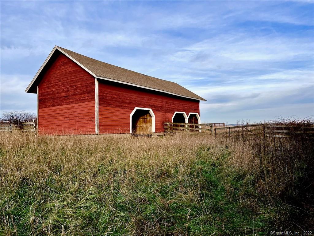 This spectacular parcel of land is situated in one of Millbrook, New York's premiere locations. Open fields with vistas rolling far to the East and South. Central to everything. This 20 plus acre property is surrounded by 1200 acres of protected land. There are three original barns, chicken coop, and two potential income properties; one dating back to the 1800's.This is what dreams are made of.