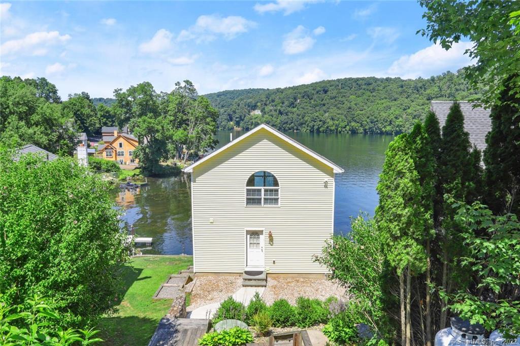 Direct Waterfront Property. This unique, sun filled,  three level contemporary colonial (rebuilt in 2006) is directly on Lake Zoar and surrounded by natural views of the state park across the lake.  Spectacular lake views from all rooms.An incredible destination to vacation and enjoy Lake Living. There is nothing quite like waking up and watching the sunrise over the glistening water.  Experience the restorative power of nature. Being on the water and breathing clean air is calming and can reduce stress and improve sleep. There are also many water activities you can participate in: swimming, kayaking, paddle boarding, fishing, boating. Upper level features an expansive primary bedroom with a wall of windows and balcony. Hardwood floors throughout , From the lower level kitchen and entertainment area you can walk-out to multi-level decks. Also enjoy the rare lake level boat house and private boat dock. One kayak is included. Close proximity to a private community beach and boat ramp. Just minutes away from Newtown's shopping, fine dining restaurants, I84 & RT34, and Treadwell Park. About 1.5 hours from NYC.Rental terms are flexible. Home furnished. Maximum occupancy is 4 people. No pets.