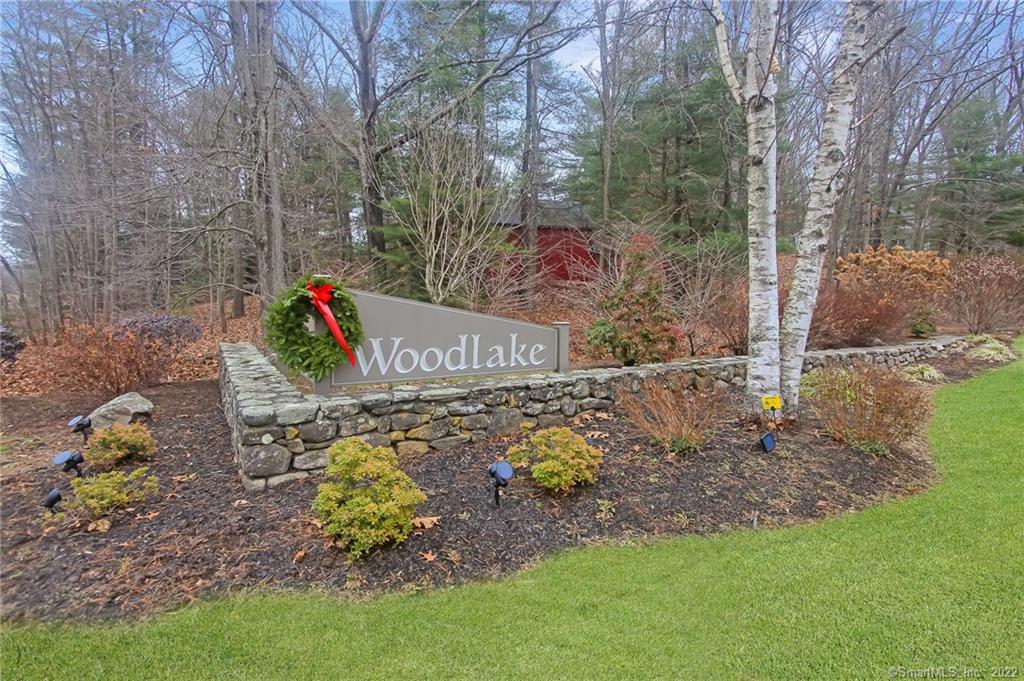 Back on the Market - buyer stopped performing. What an amazing opportunity to live in one of the most scenic & beautiful complexes in Litchfield County! Woodlake community provides non-motorized boating on the lake, hiking trails in the many acres surrounding the community, basketball courts, four tennis courts, children's playgrounds, and more. Come see this spacious 2-bedroom, 2.5-bathroom home, an end unit, in a private & peaceful location. You'll find an updated kitchen with stainless steel appliances & granite countertops, newer extended deck w/French doors from both the Livingroom & kitchen, Livingroom fireplace equipped with a newer pellet stove providing ambiance while helping with keeping heat costs low, all three bathrooms are updated with beautiful fixtures, the interior is freshly painted, a large room in the lower level is great for a potential home theater room, exercise area, den and/or office. This complex is for nature lovers! Experience a getaway at home. Just minutes from Woodbury center boasting great antique shops and boutiques, many award-winning restaurants, inviting historical inns, a tree-lined main street, and more. This community is located about 10 minutes from additional high-end shopping, larger grocery stores, and I84 for commuters. Community services include beach access, security services, ground maintenance, trash pickup, water, sewer, and road maintenance. Seller related to agent.