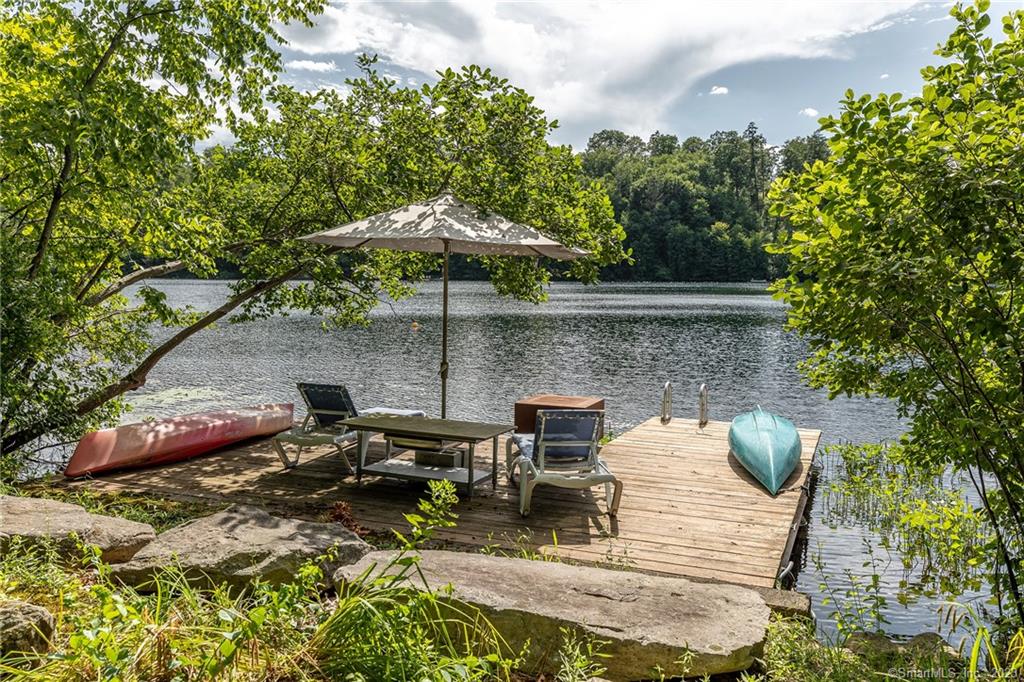 The Fischer House - a waterfront property and setting like no other! Designed by renowned architect, Norman Jaffe, the home is located on the beautiful, pristine lake, known as Green Pond. Jaffe was an innovator in using natural materials and was widely known for designing strikingly sculptural homes. His romantic sensibility is evident throughout the rooms, with their showcase windows of the lake and surrounding trees, their rough hewn paneling, multiple skylights and vaulted ceilings. Four bedrooms, plus a sleeping loft, provide room for everyone. The primary suite offers its own Bath and adjoining meditation/exercise room. Each of the other three bedrooms offers a private sink and shares a full bath with an adjoining sauna. There is an outdoor shower and steps down to the lake to one's own private dock. Green Pond is known for being one of the cleanest and most serene lakes in the region. Its spring-fed waters are ideal for swimming and non-motorized craft. Kayaks, paddle boards, canoe and hammocks are available and on site. Tenants also have access to two private community beaches on Candlewood Lake. The home is an historic example of Jaffe's rustic modernist designs and is owned by the son of the original owner, famed photographer Carl Fischer, known for his iconic Esquire covers. Less than two hours from NYC and minutes to Metro North trains. Available to rent for the month of June for $16K, July for $18K, August at $20K, or from Memorial Day to Labor Day for $50K.