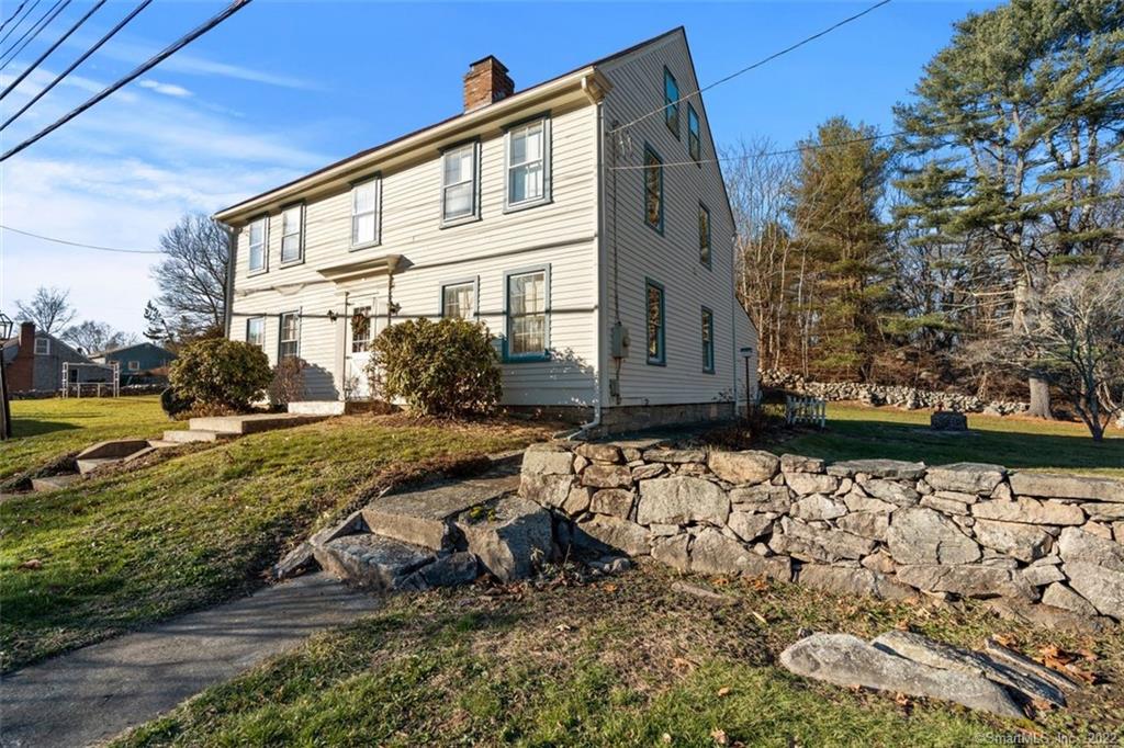 MYSTIC!! MYSTIC!! Historical home steeped in the history of early America. Built in 1770, it has the stone marker, noting it was an inn and stagecoach stop between Boston and New York. Much of the original architecture has been retained; wooden staircase, exposed beams, wide board floors and antique fireplace with Dutch Oven in the Gathering Room. Much effort has been spent restoring and maintaining the quality of this spcious home. Come view the original Colonial Pantry, large bedrooms and colonial cooking woodstove. There are 5 fireplaces, 4 of which have been sealed, with the possibility of re-opening. There are also 3 full baths with an additional one plumbed on the 2nd floor.In Springtime enjoy all the plantings on the grounds including: apple trees, grape arbor, multiple flowers and herbs and large yard with stone wall to grow your own vegetables.Located just on the outskirts of downtown Mystic and walking distance to Old Mystic.10-15 minutes to military bases and beaches.