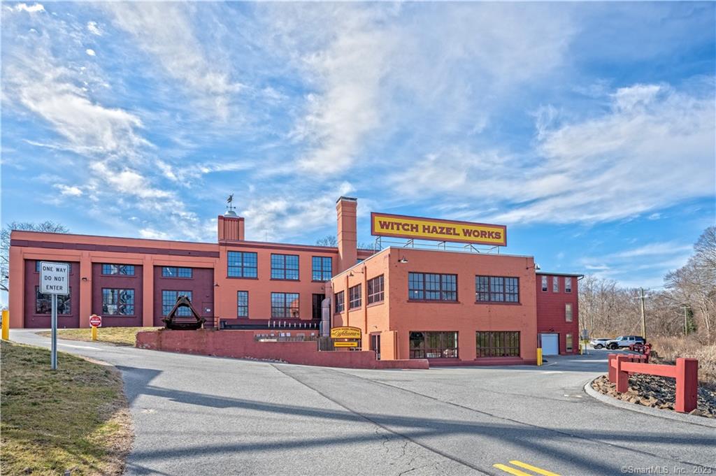 The Witch Hazel Works Complex, a historic gem in the Village of Centerbrook in the Town of Essex, Connecticut, is a prime example of adaptive reuse and a model for sustainable development. Located along the scenic Connecticut River, just five miles north of the entrance to the Long Island Sound, this remarkable property once housed the headquarters and factory of the E. E. Dickinson Company. As of March 15, 2023, the Witch Hazel Works Complex is fully leased, boasting a diversified tenant list that includes professional, medical, media, financial services, corporate headquarters, restaurant and brewery, and event spaces. The complex has an undeveloped rear parcel and major infrastructure investments, offering potential for future growth and development. The complex has also recently completed a major environmental cleanup of historical coal ash deposits, with an Environmental Land Use Restriction (ELUR) on file with the Connecticut Department of Environmental Protection.