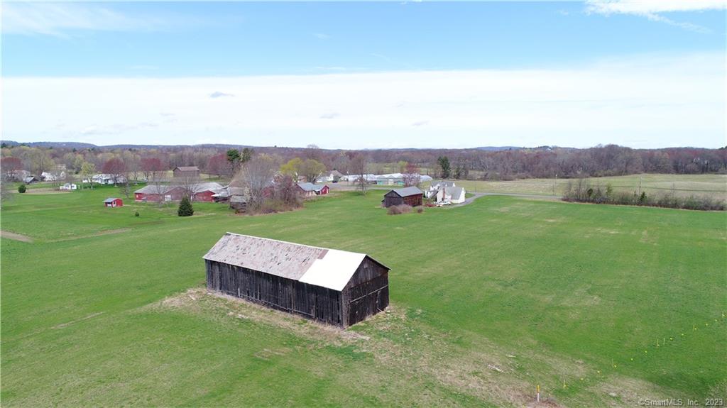 The possibilities are endless with this 11.9 acre property, as it abuts one of the largest available pieces of sub-dividable land in Suffield which combined would offer sewer, water and gas. Sitting on the cleared, level, open-spaced land are two full-sized barns and a detached garage and a 1, 778 sq ft 2 family house. Great location 3 blocks from the center of Suffield, with easy access to I-91, only 15 minutes to Downtown Springfield, 23 minutes to Downtown Hartford and 7 minutes to Bradley International Airport. Opportunities abound with this income producing property. Situated on a beautiful 11+ acre pastoral setting, the versatile layout of this home can be 3 bedroom with in law option or au pair option, with full kitchen and baths on upper and lower levels. Could also be configured as 2 separate units one up one downstairs. New roof done in 2014. The property is ready for your horses, hobby farm, agribusiness ideas or subdivide! You'll have all the charm of yesterday with all the amenities of today. The home had a new roof in 2014. Call today for your personal tour!