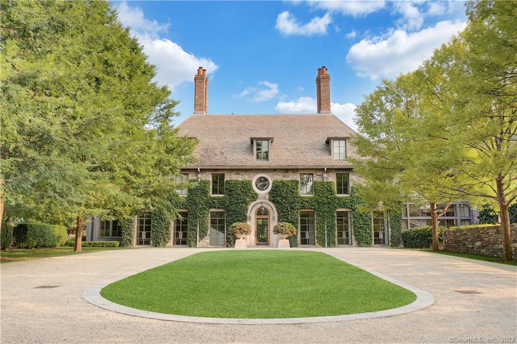 Exquisitely designed and built mid country home that is truly one of the most special homes you will ever see. This private, gated 5+ acre estate, harmoniously combines modern and tradition aesthetics while using the finest materials and workmanship. Enter the tree lined gravel driveway to one of the most elevated lots in Greenwich, with views of Long Island Sound from multiple rooms. A light filled first floor features a grand entry hall leading to a superb office with bathroom, bar, and exterior door leading to wonderful wildflower gardens and lawns designed by Reed Hilderbrand. Grand scale formal living room. Large, bright, fully equipped kitchen with dramatic onyx counter tops and expansive metal framed windows overlooking the rear gardens. Beautiful pocket doors can screen all catering areas for more formal entertaining. Large family office / homework area, family room. Sun filled hallway connects to mudroom, parking, 4 car garage and staff office, complete with shower, kitchenette and laundry. Master suite with large deck, his and hers bathroom areas, and large, separate WIC's. 4 further bedrooms on the second floor, all ensuite and oversized laundry area. Third floor features a billiard room / entertaining area with views of the water and NYC. Large 6th bedroom suite, with views, which could also be used for a very private office area. Lower level includes media room, large gym with natural light, library and a connecting underground